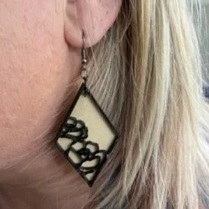 blonde girl wearing wooden floral Treble Market earrings