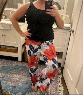 Woman wearing bright floral pajama pants