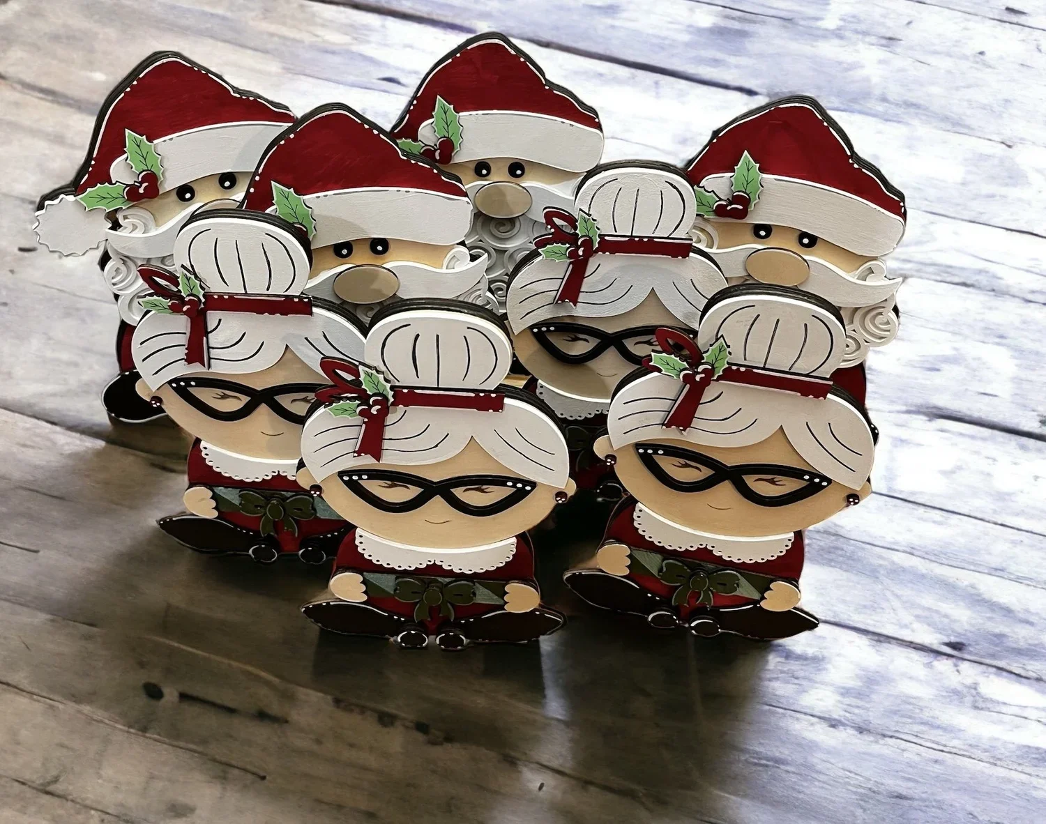 Image of multiple Santa and Mrs. Clause figurines