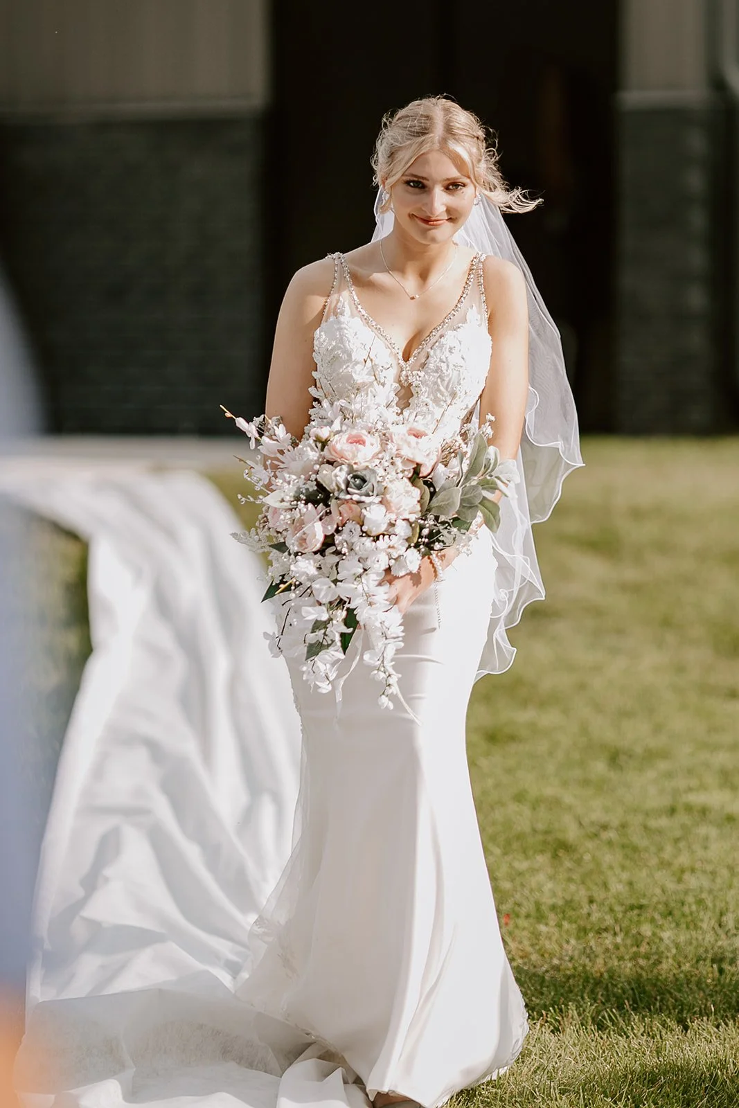 A central Iowa bride walking down the outside ceremony