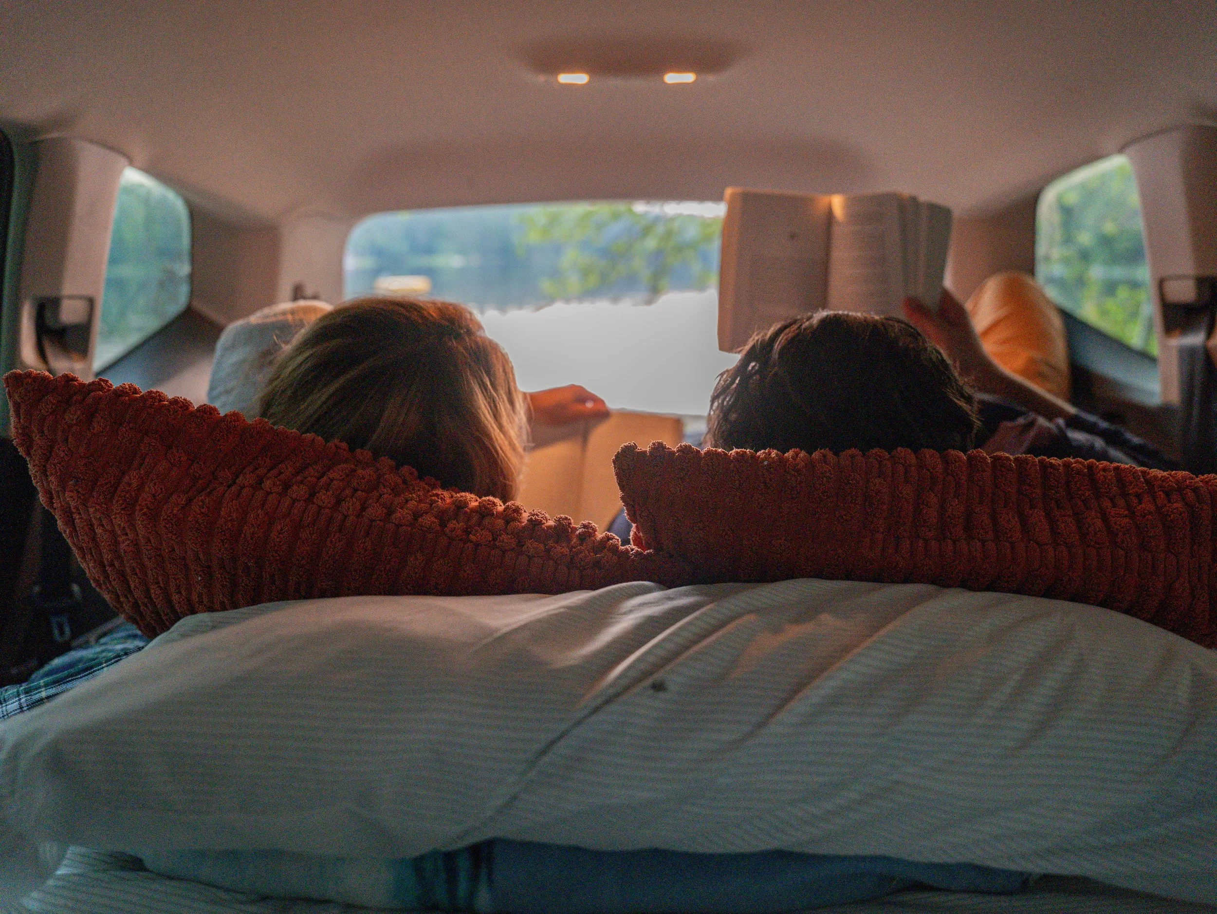 Back view of Rob and Ashley reading while laying in the Quest Nest by G&G Upfitters
