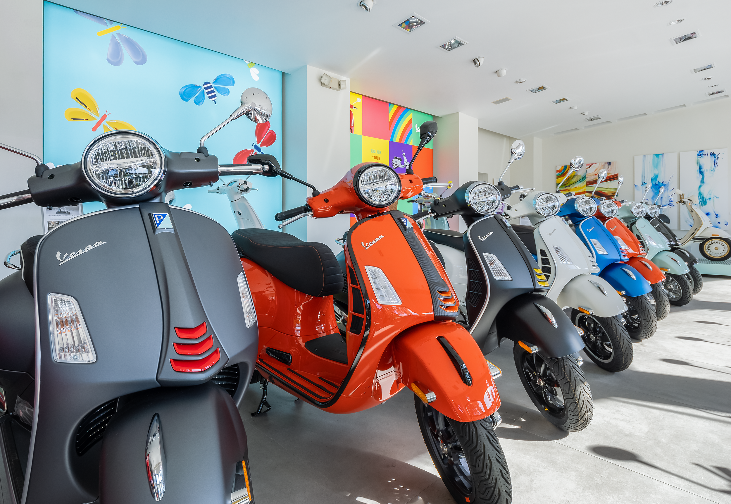 colorful-vespas-lined-up-in-showroom.png