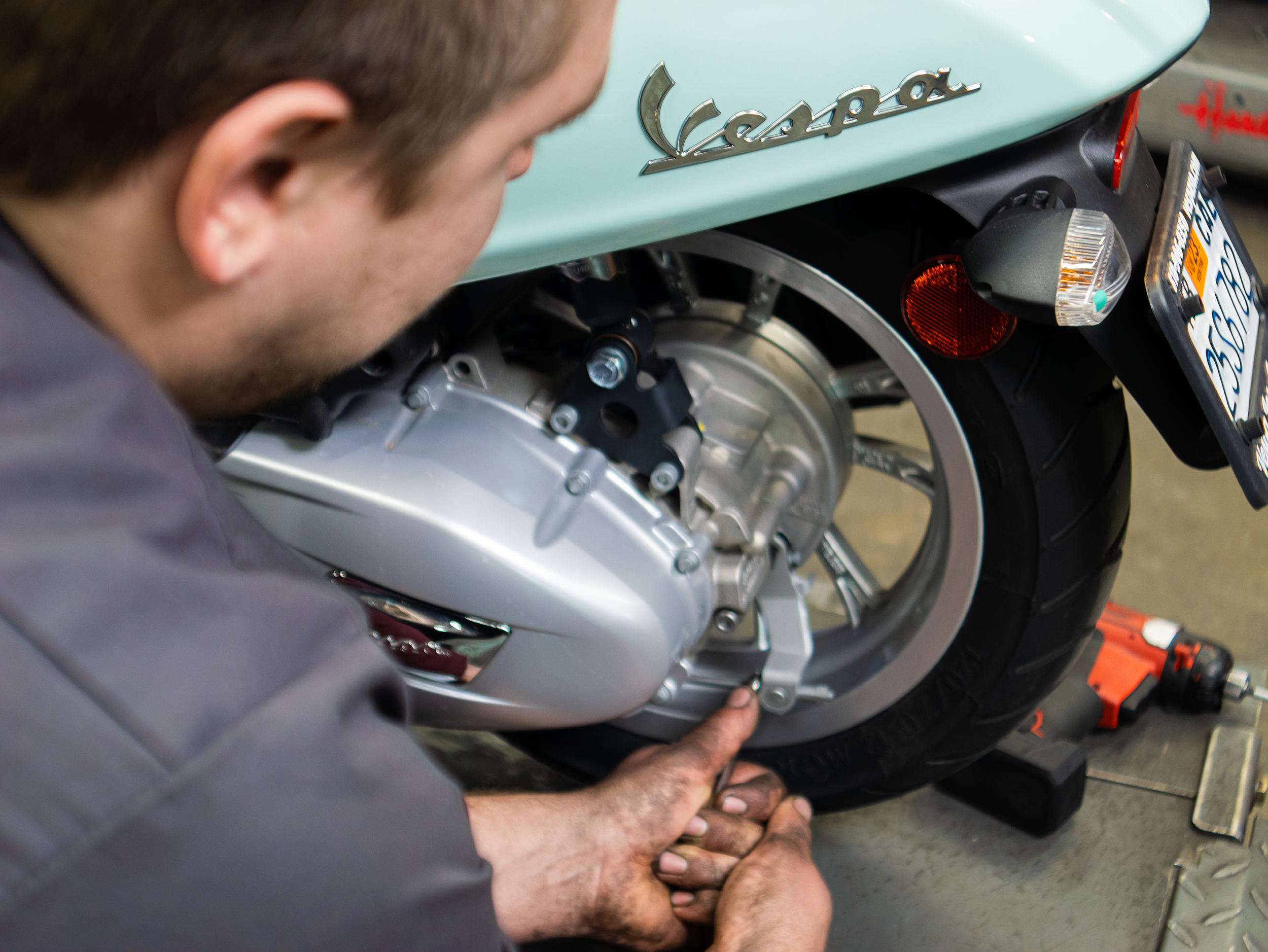 serviceman-repairing-vespa.png