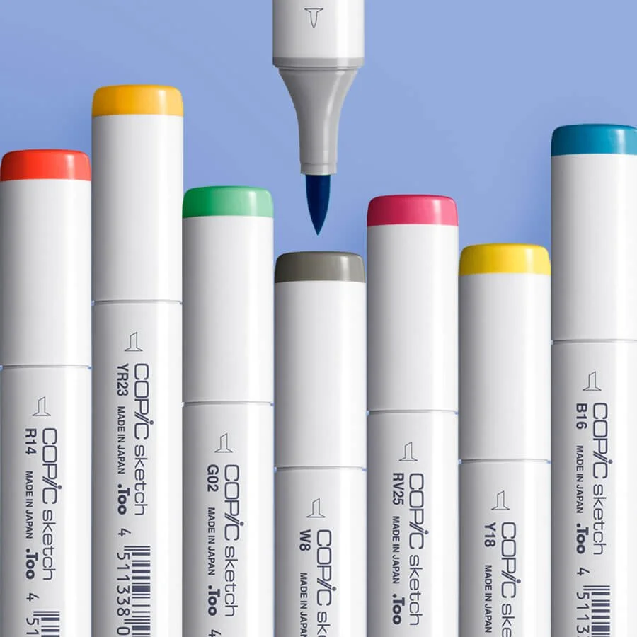 Copic Sketch markers in color assortment on blue background