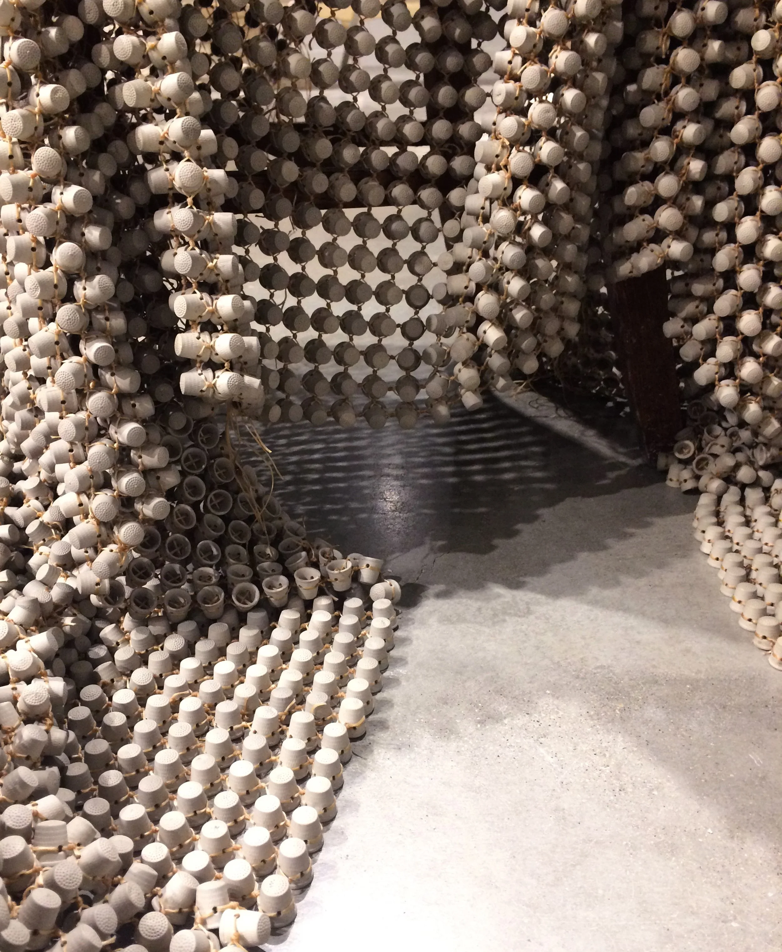 10,962, detail, 2017. Porcelain, waxed thread. Allison Gailey, formerly Allison Craver. Installation view, Safe | Passage, Urban Art Space, Columbus, OH.
