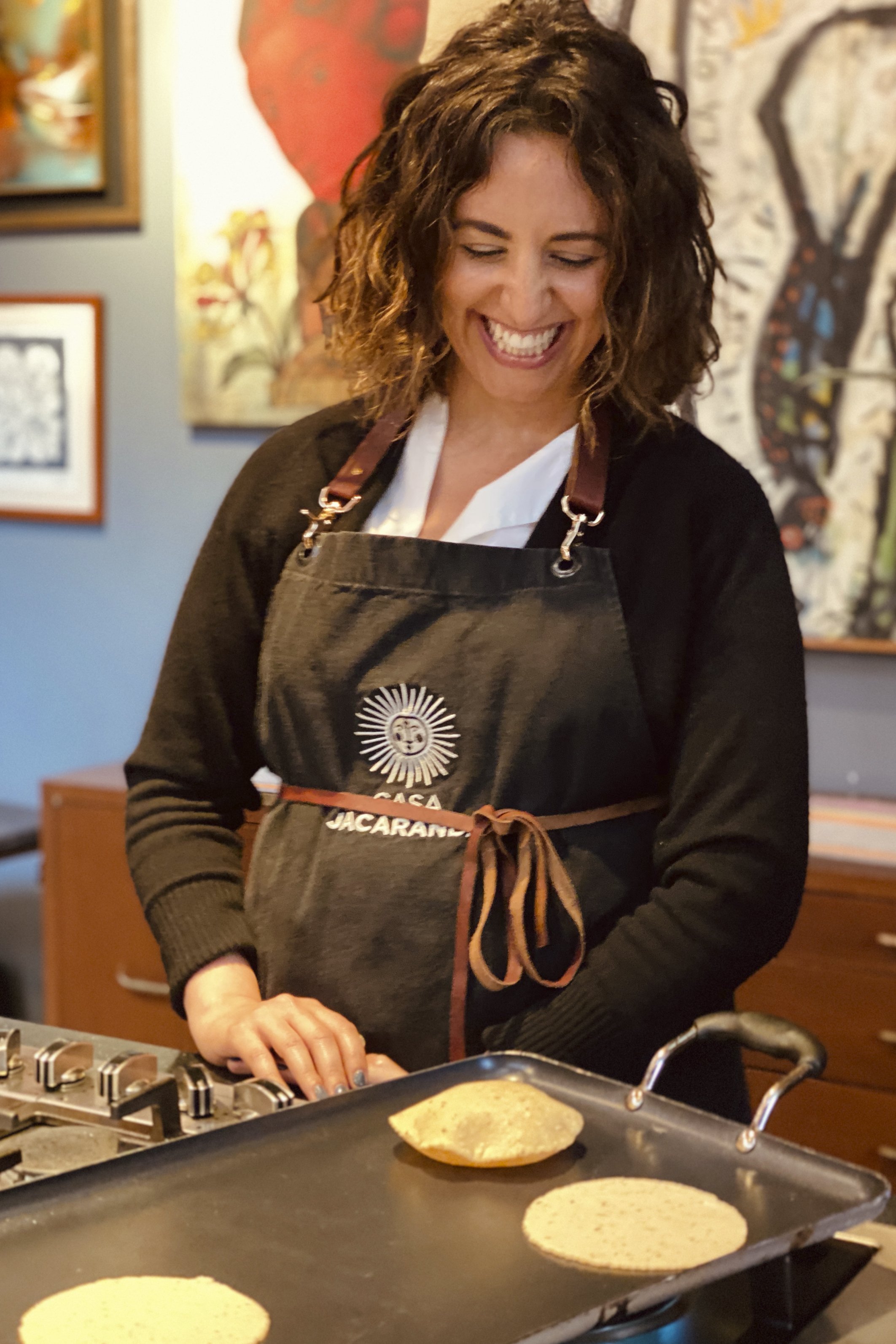 Smiling Female Casa Jacaranda Student Presides Over a Griddle