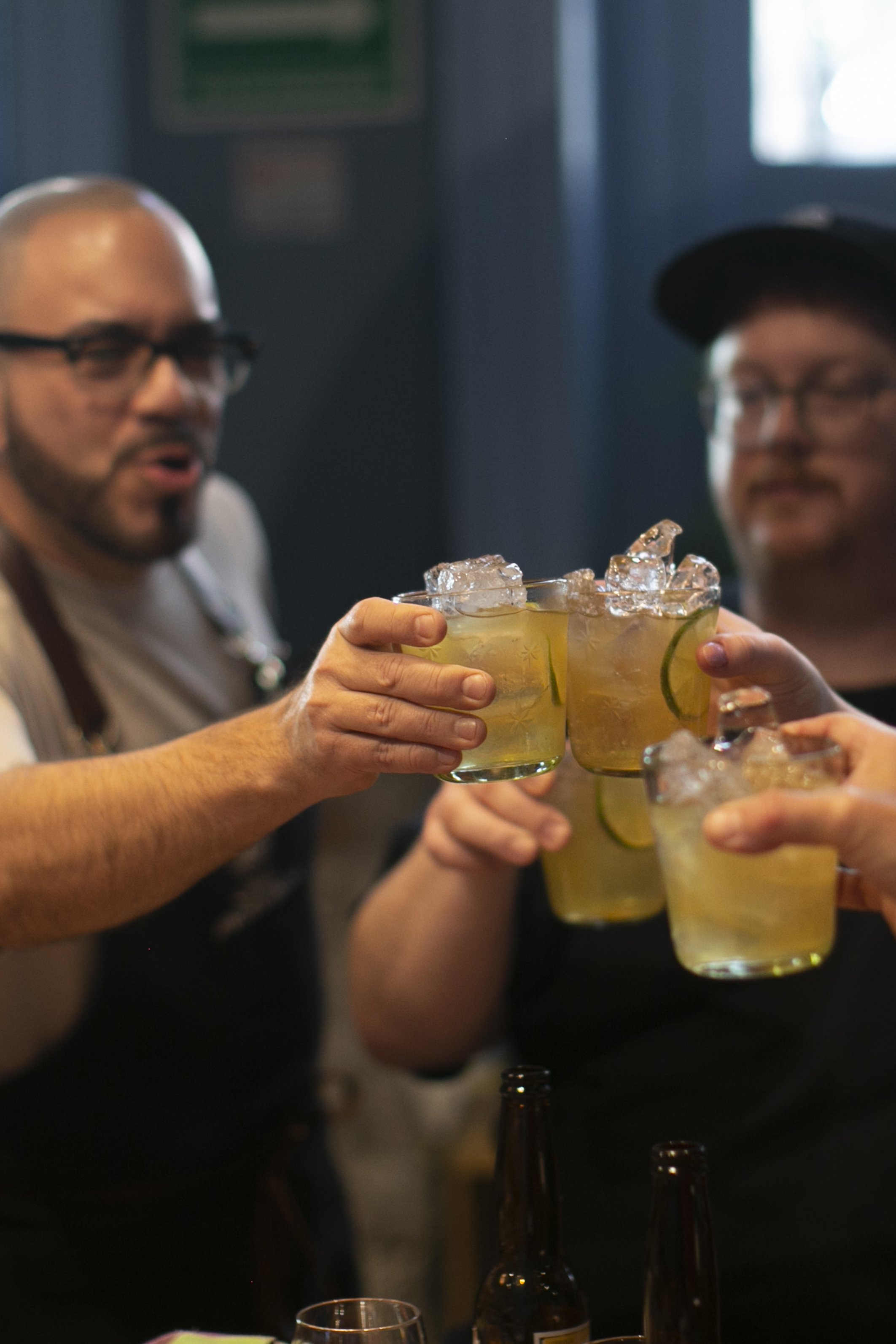 Chef Jorge clinks glasses with students with a post-cooking class cocktails