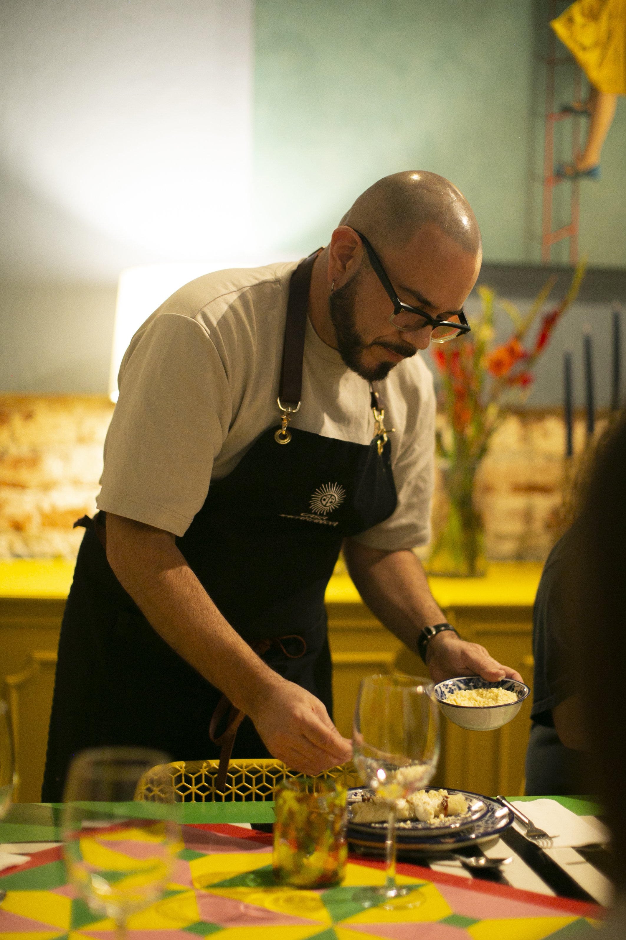 Chef prepares Mexican food at table 