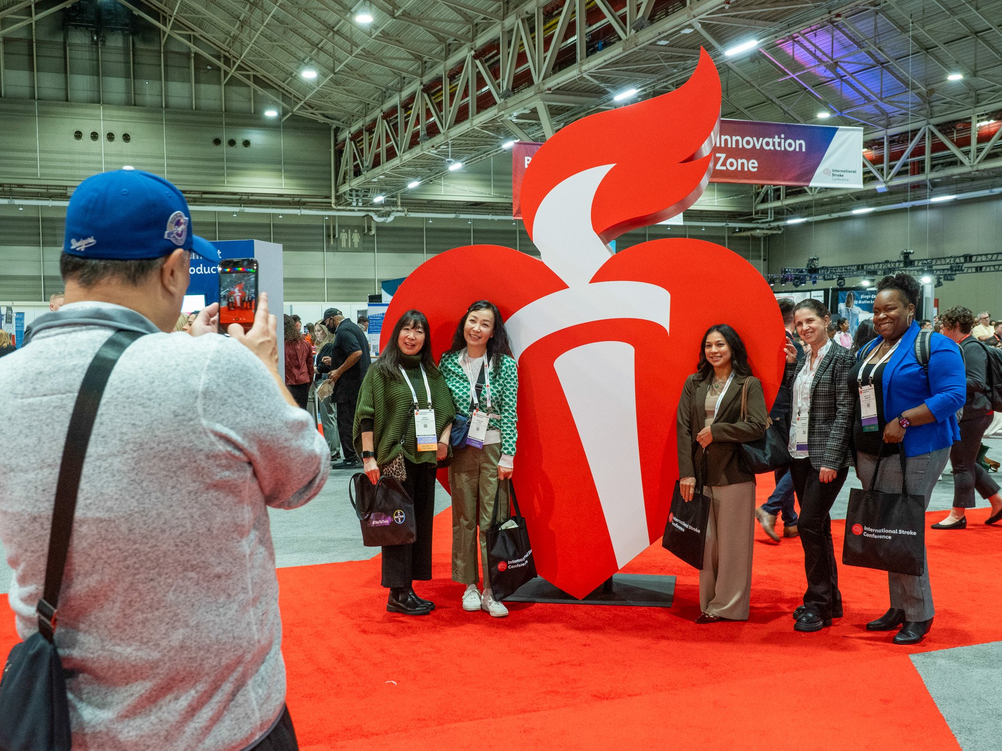 Attendees take photos with heart torch