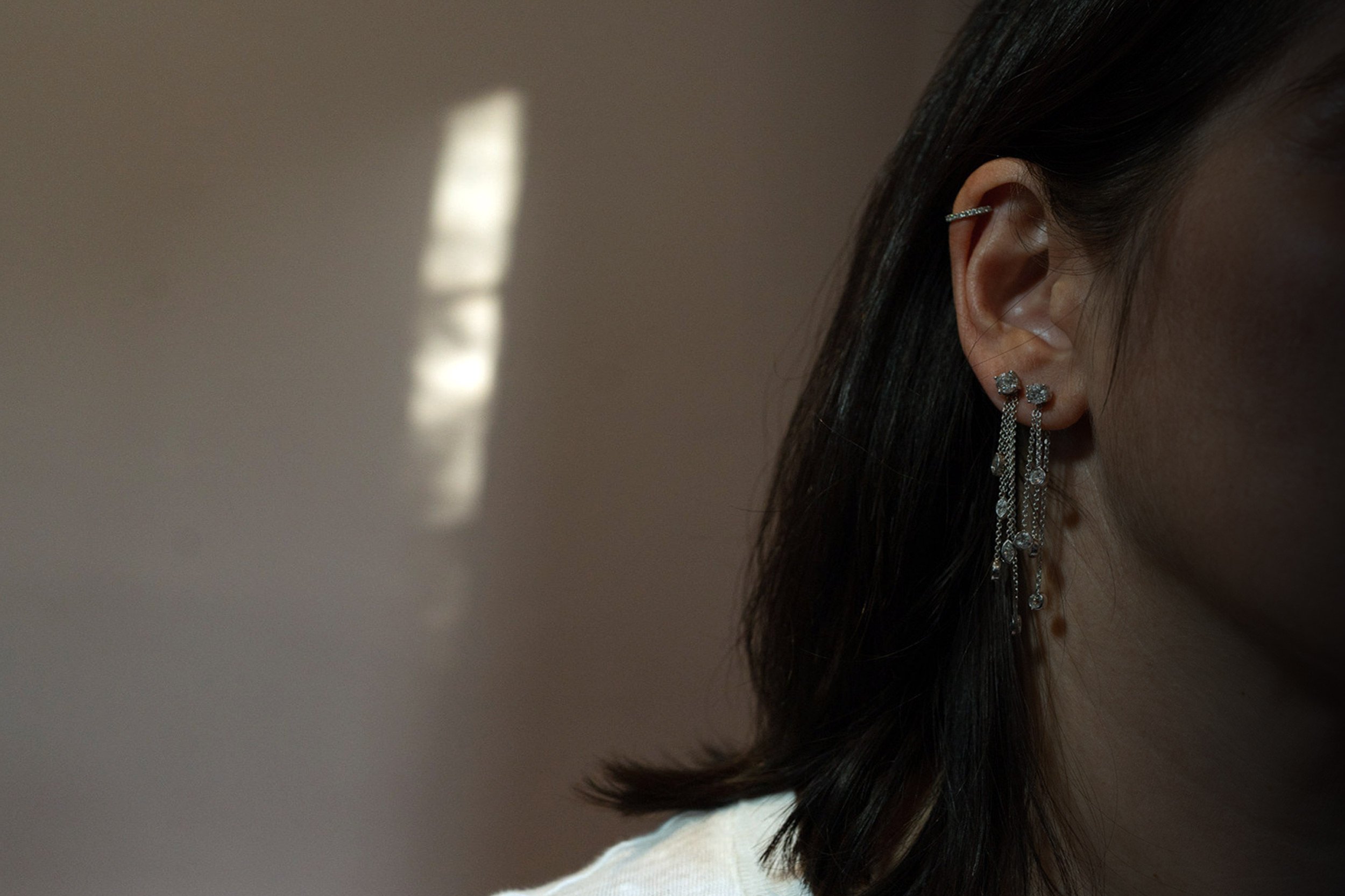 white-female-wearing-diamond-earrings-and-earcuff.jpg