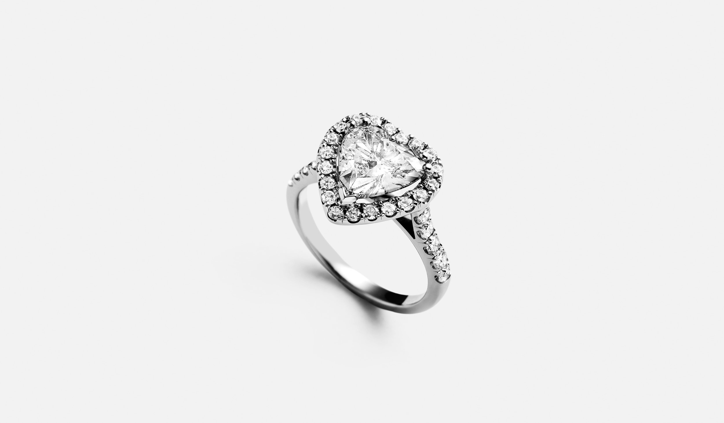 white-gold-heart-diamond-ring-surrounded-by-small-diamonds.jpg