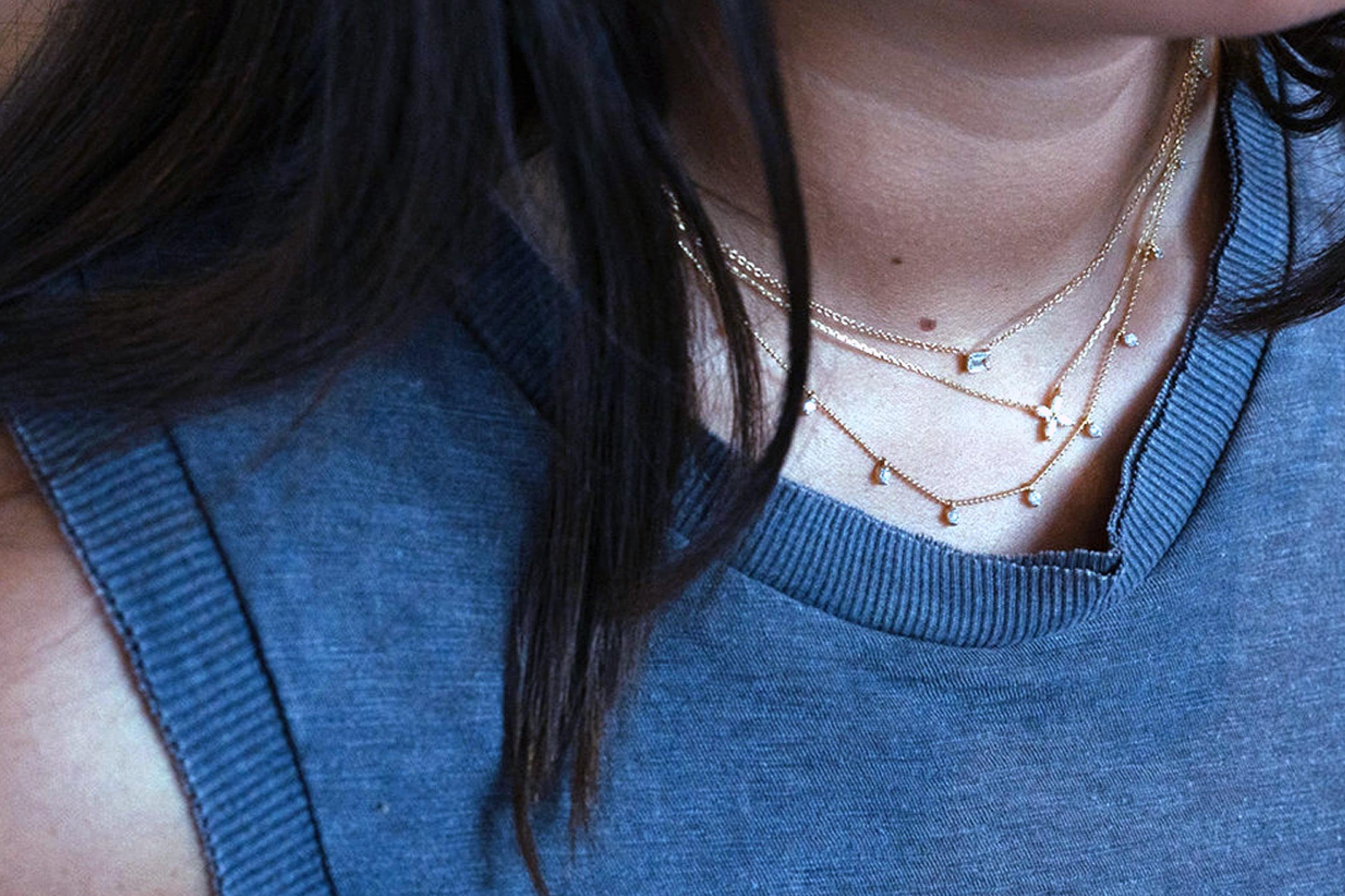 white-female-wearing-three-gold-necklaces.jpg