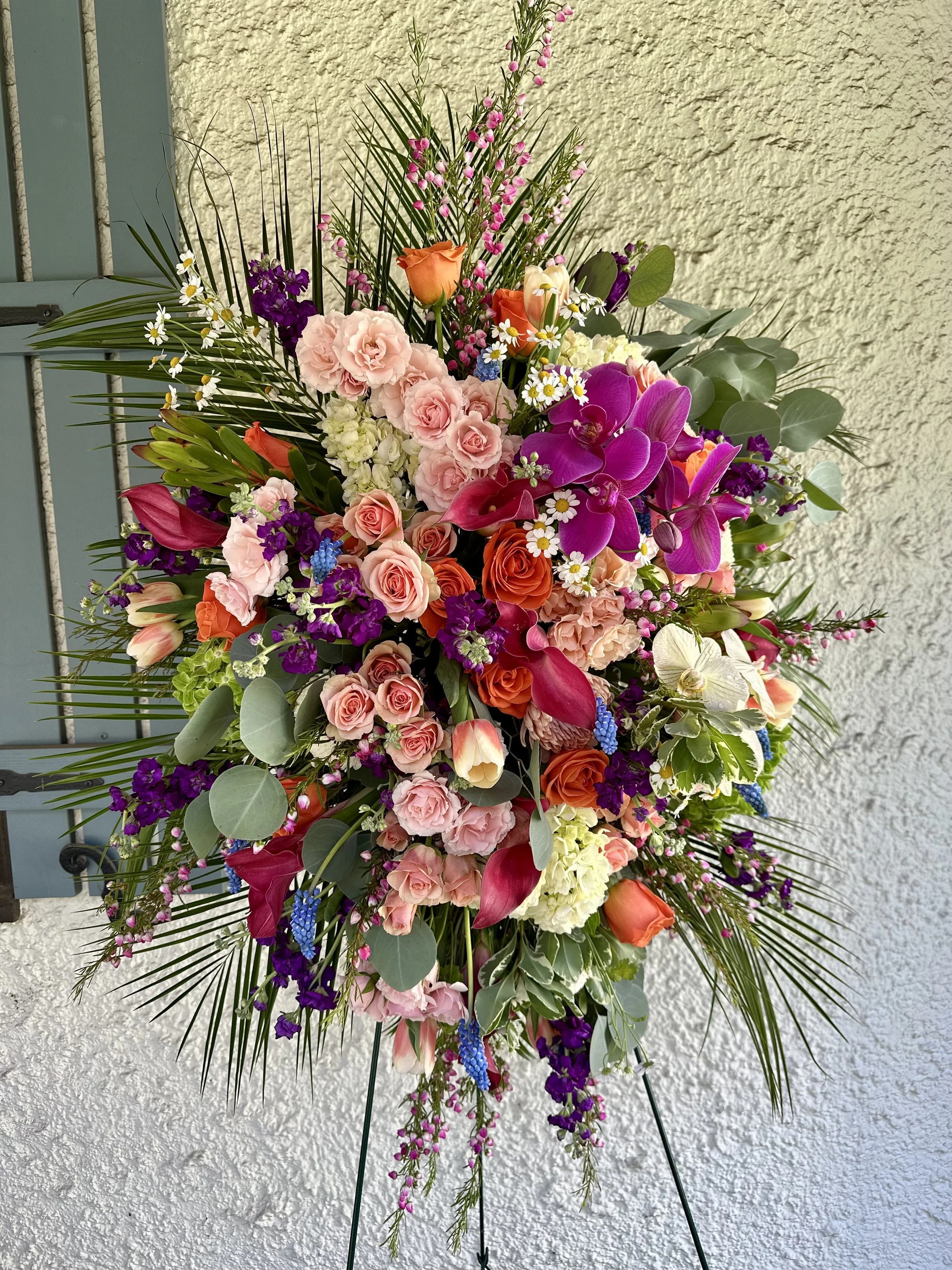 Funeral spray with orchids and roses. Bright celebration of life flowers. Dee's Floral Design. Longmeadow MA