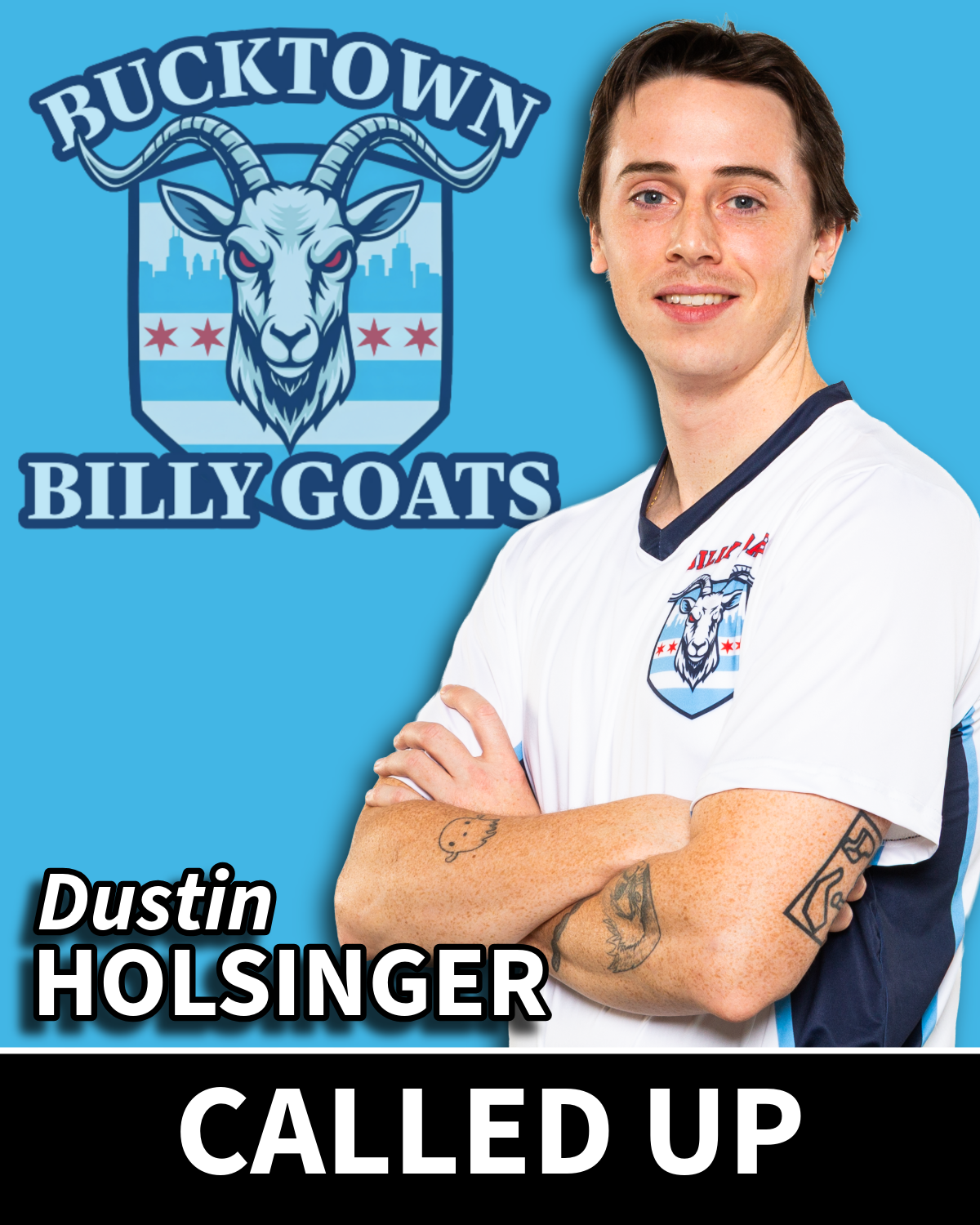 A person with tattoos on their arms wearing a white sports jersey with a Billy Goats logo, standing in front of a blue background with a team logo and the text rising from the logo. The person has short dark hair and is smiling with arms crossed.
