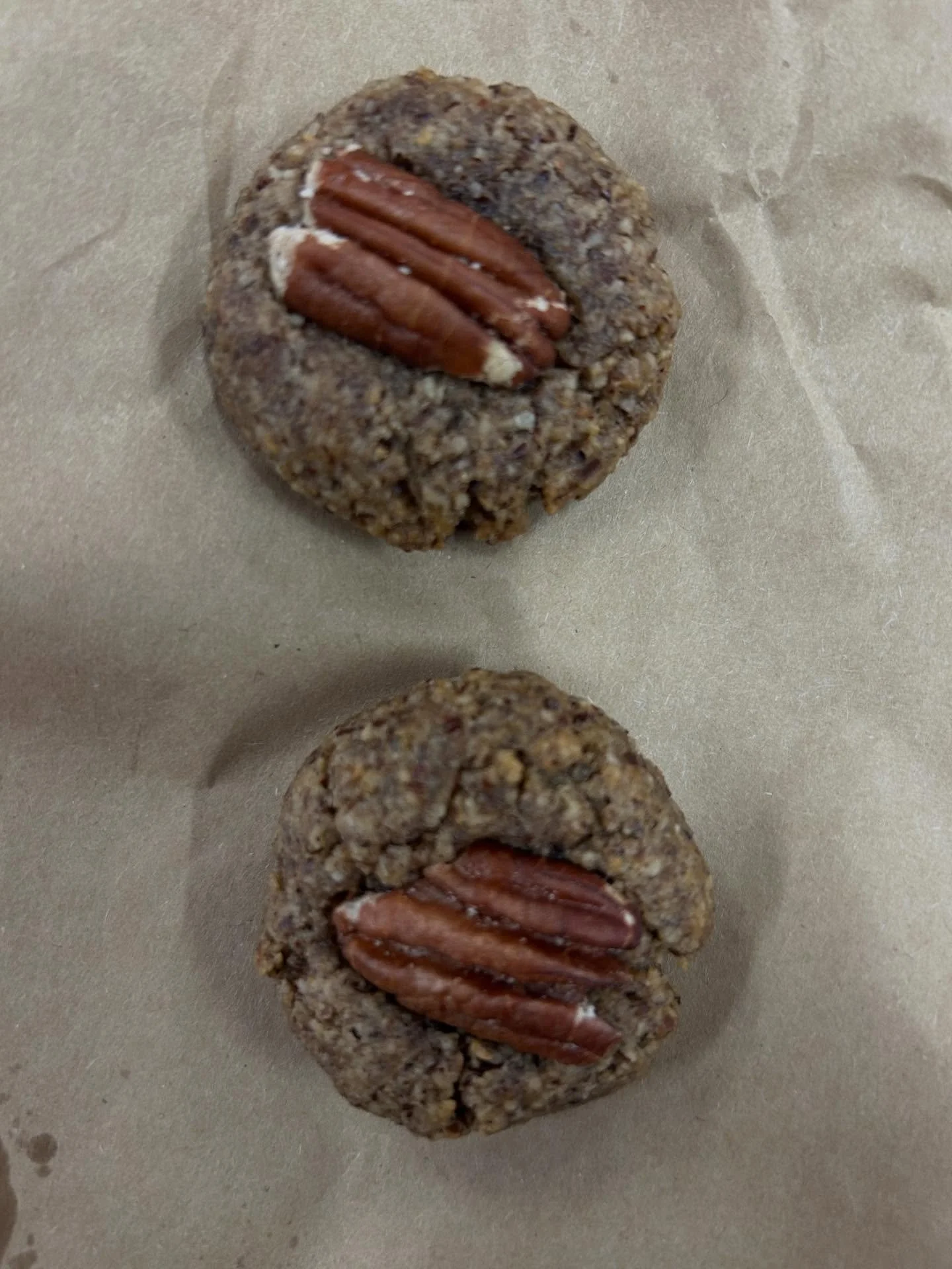 These pecan biscuits are simple, easy and delicious!
150g pecan pieces
90ml maple syrup 
Optional 2.5ml almond or vanilla extract
12 pecan halves

Preheat oven to 180 degrees C
Grind pecan pieces to a fine grind in a food processor 
Mix ground pecans