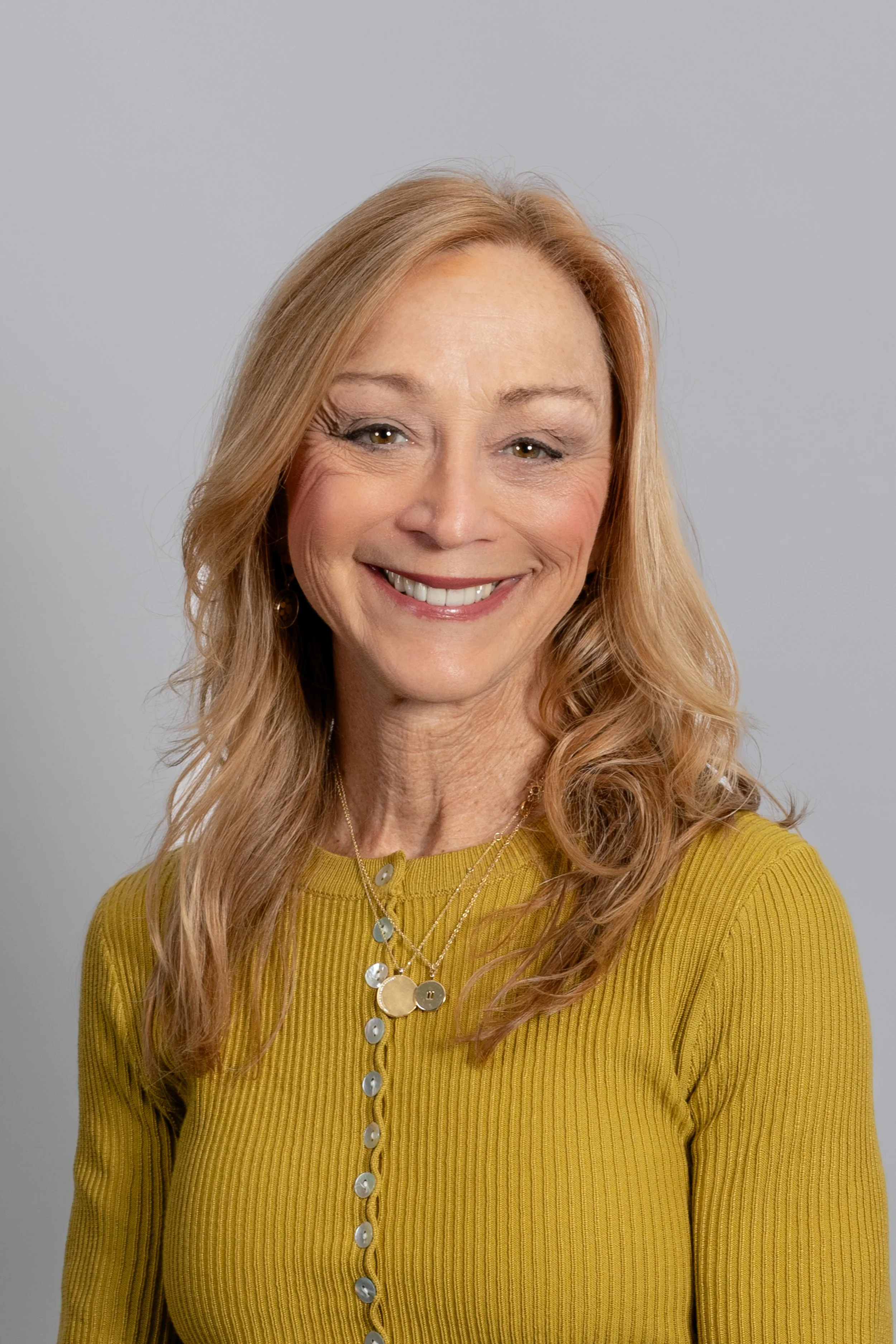 Cynthia O’Connell smiling, soft natural light, educator and mindfulness trainer portrait.