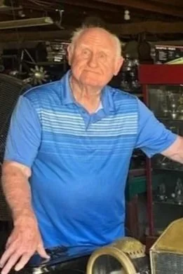 Photo of Buck Harness while in his barn and his car collection.