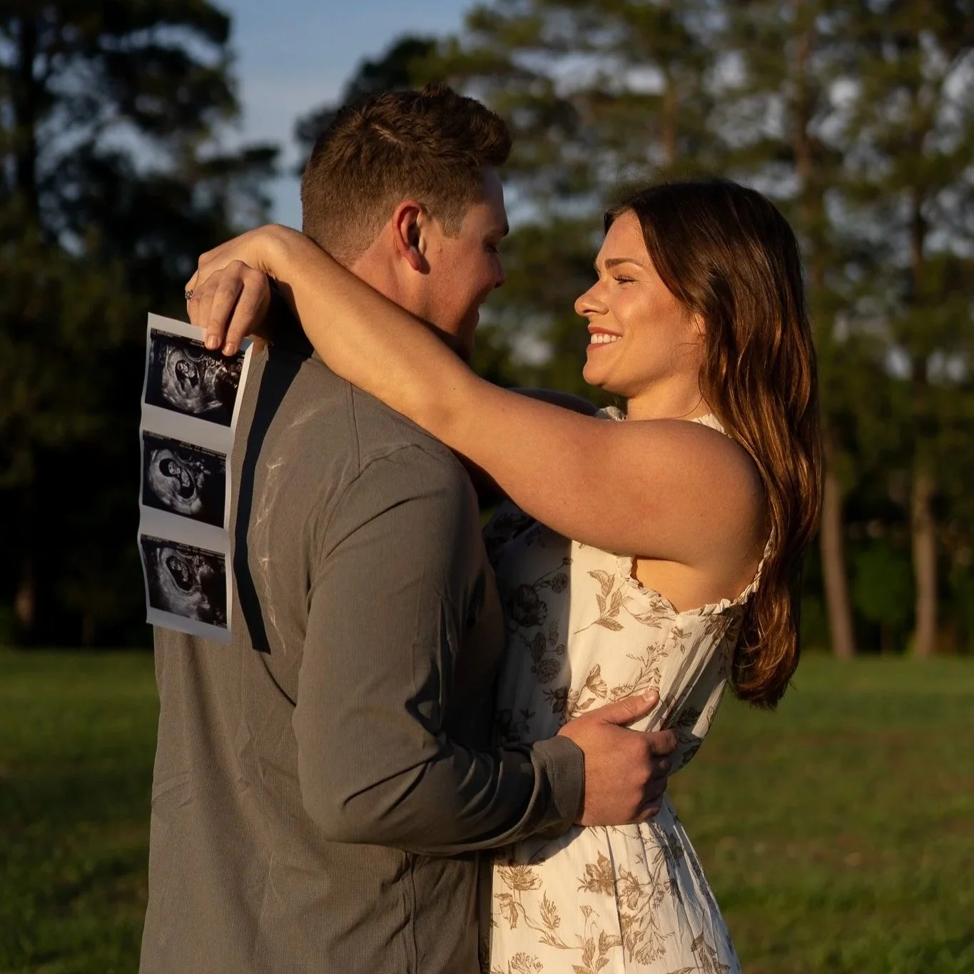 Couple picture with the sonogram of their newly announced baby
