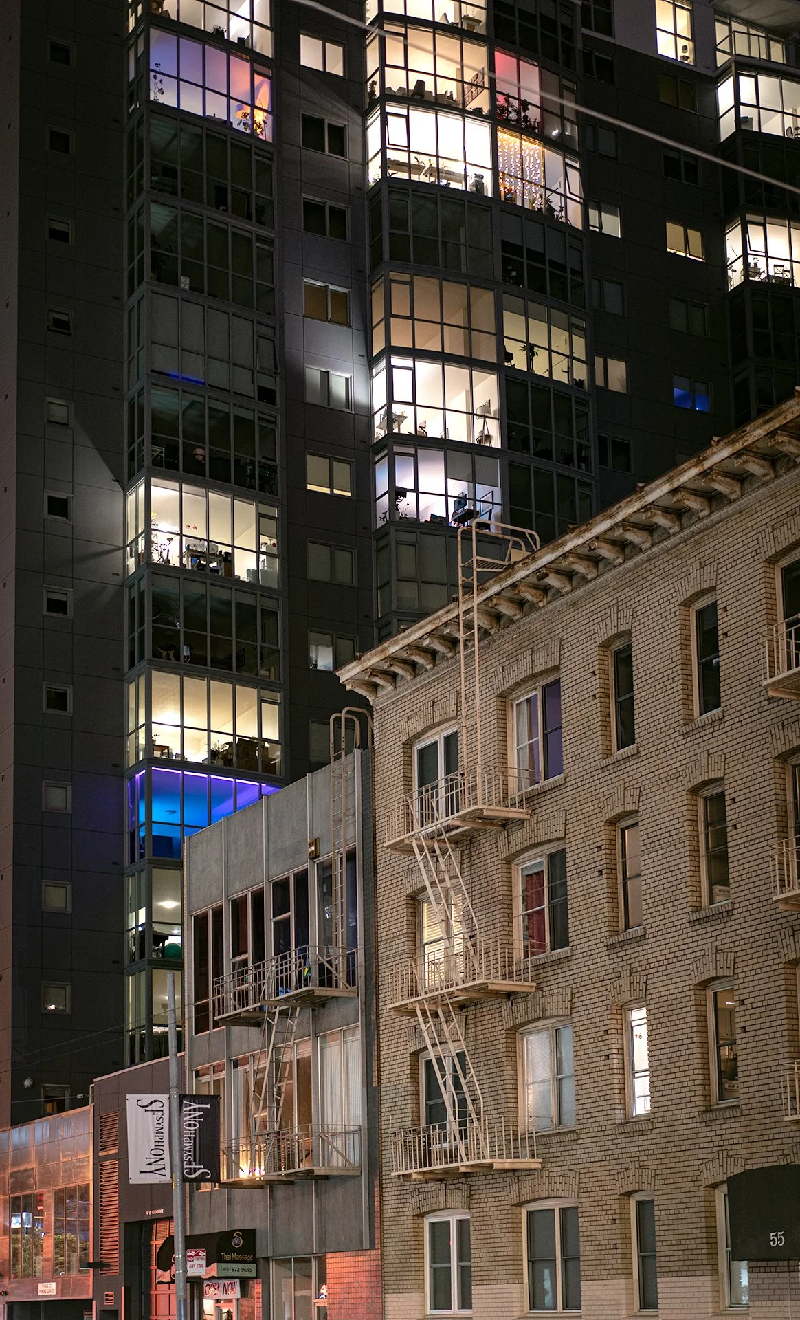 Photo of an old building with a big new building looming in the back
