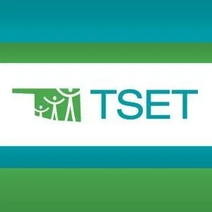 Logo with the text 'TSET' and a stylized graphic of three people with arms raised, set against green and blue horizontal stripes.