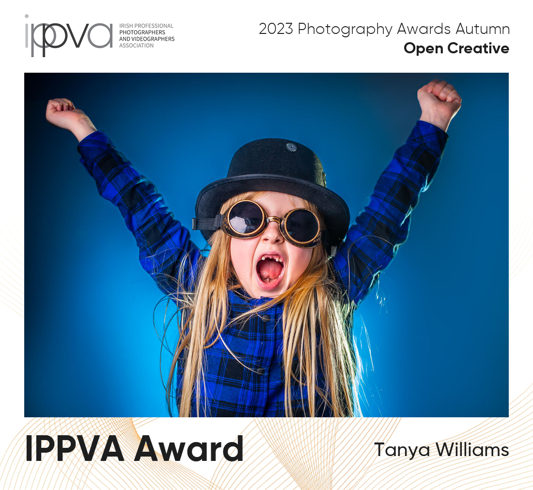 Award winning portrait photography of a boy backlit with a blue flash and his front teeth missing.