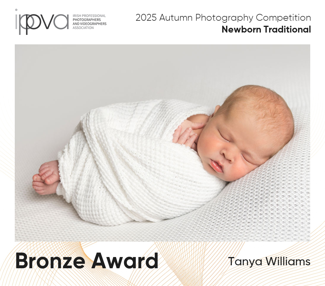 Award winning newborn photography photo of baby wrapped in white.