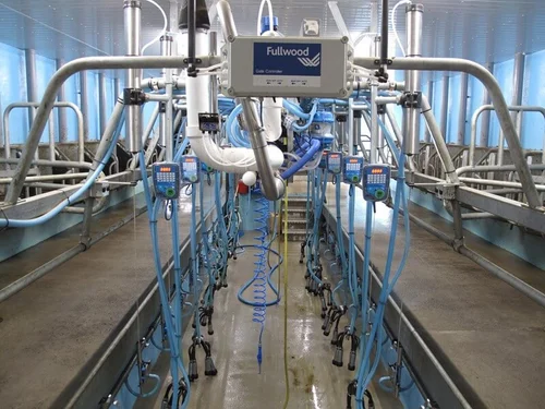 The Fullwood control box over the pit, with milking units and stall keypads running down both sides of the herringbone