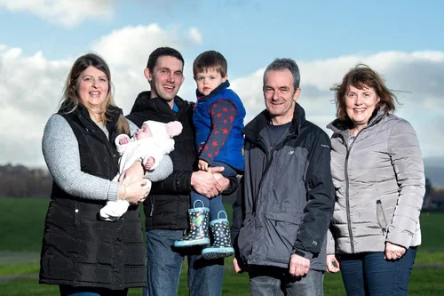 Three generations of the Brisbane family of Gartclush Farm standing together in a field
