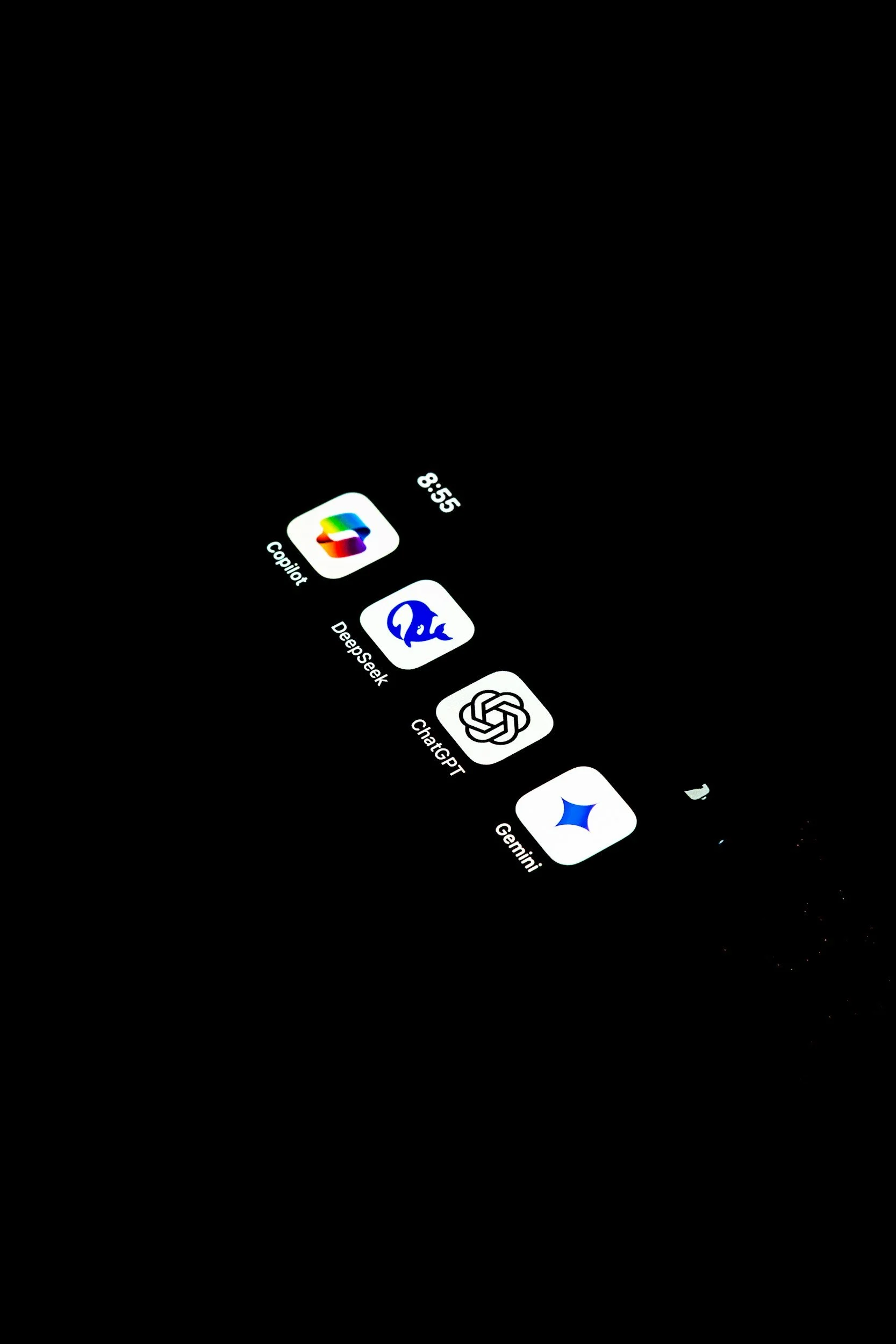 Smartphone screen displaying five app icons: Copilot, Deepgeek, ChatGPT, Gemini, and a partially visible sixth app.