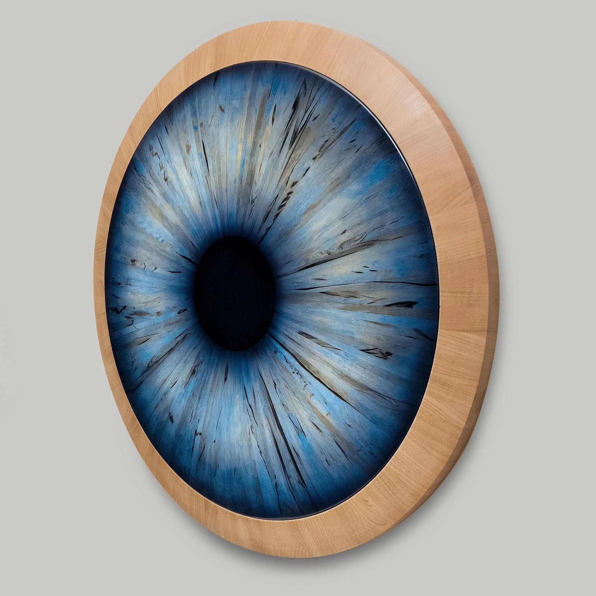 This iris is made from 168 staves of spalted Hornbeam, which have been matched and glued in a radial pattern to form a disc. 