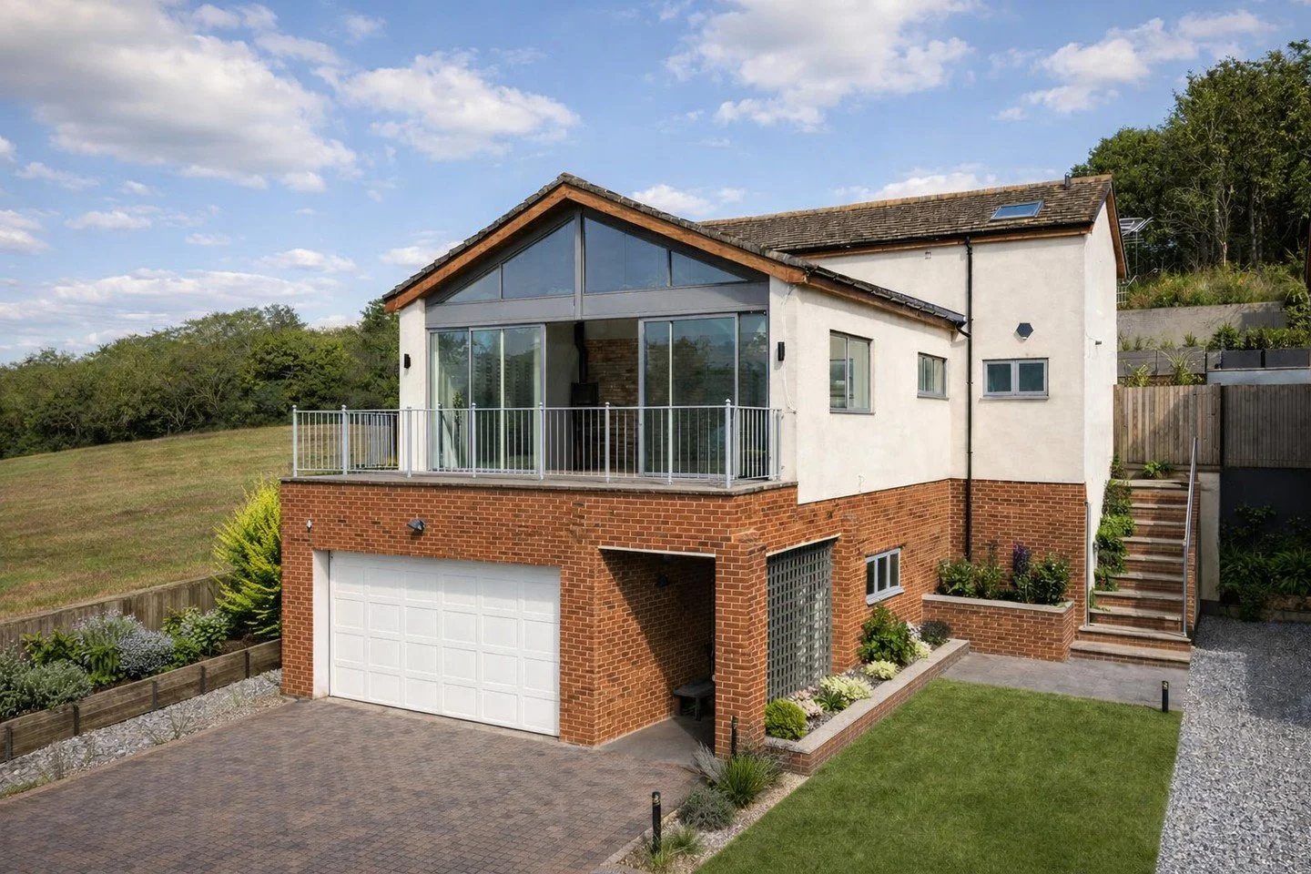 Adaptation of a small cottage overlooking Capstone Country Park lake, creating a modern home with improved space, daylight and function. A first-floor glazed gable frames the views and fills the living areas with light.