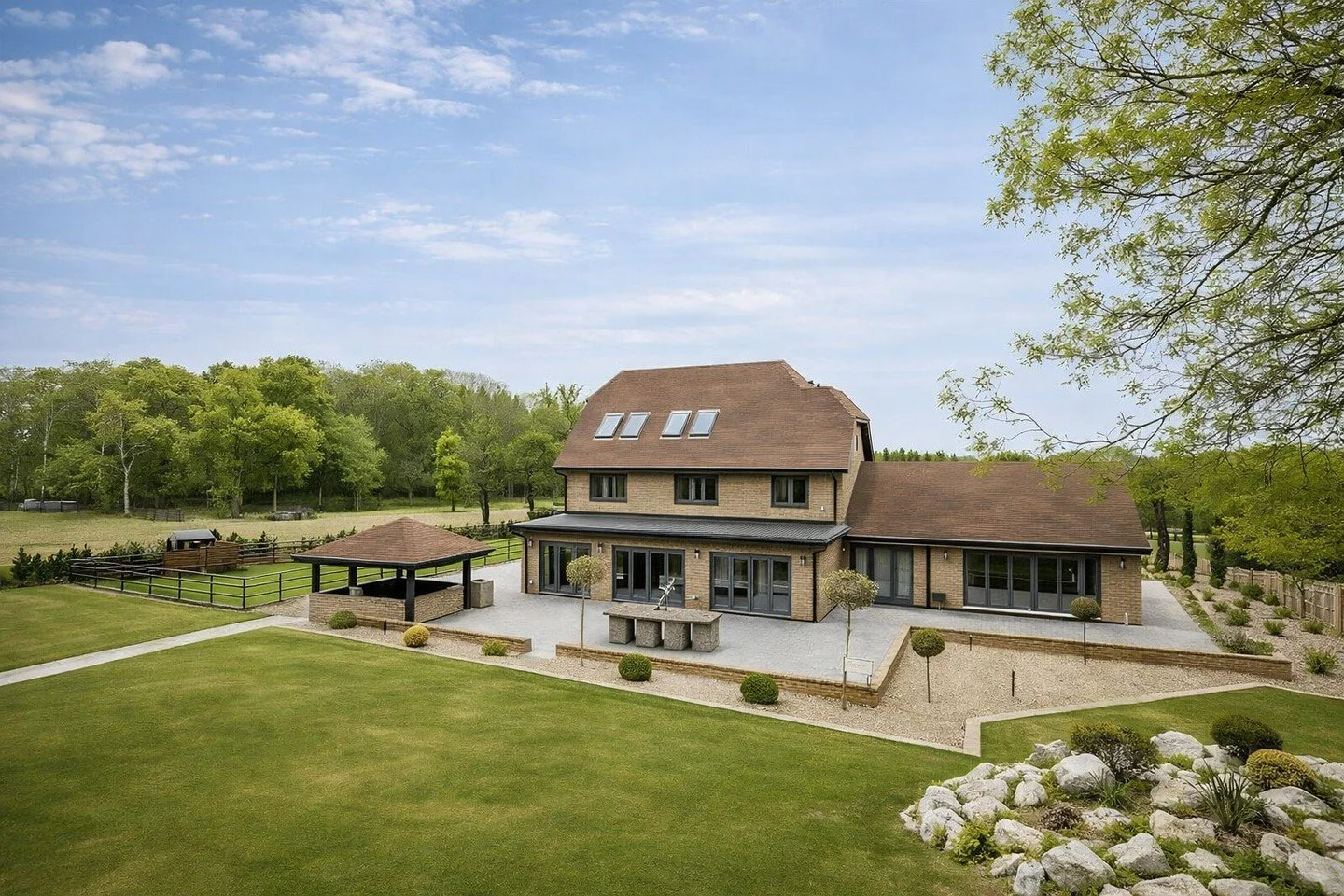 A complete house overhaul with external remodelling, new side-and-rear extensions, loft conversion; dramatic entrance hall opened around a sculptural new stairwell with gallery view through all floors