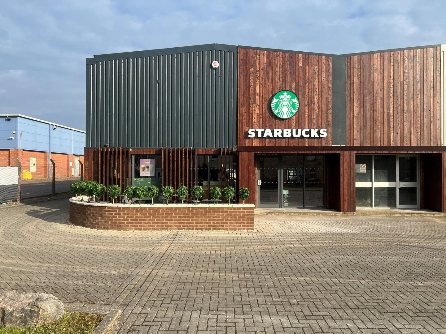 Conversion of a dated industrial unit into Starbucks at Kingsteignton Trading Estate, Newton Abbott - their first food &amp; beverage offering and a transformation to the front of the estate