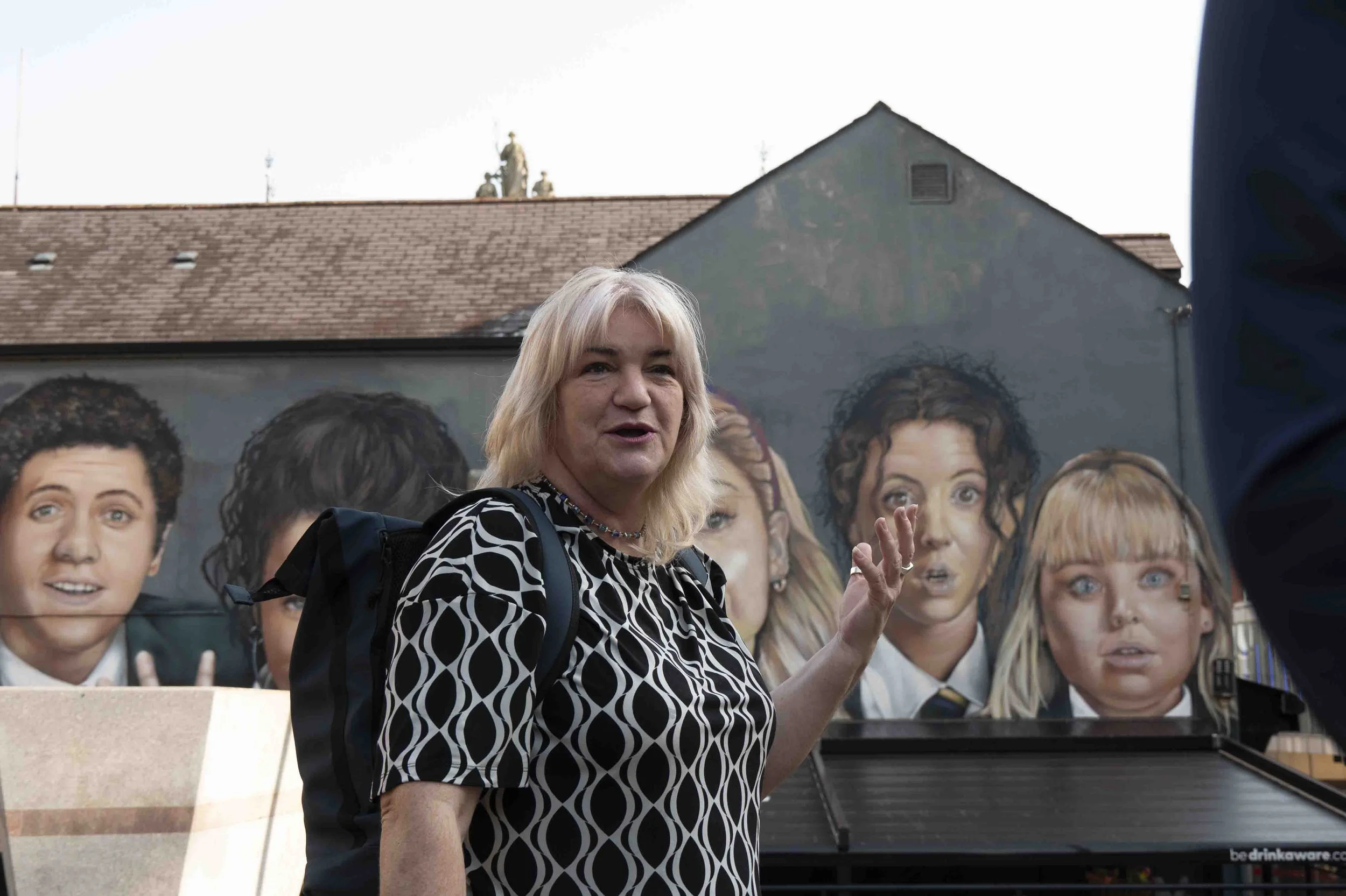 Ann Walker, former republican activist, with Derry Girls mural 