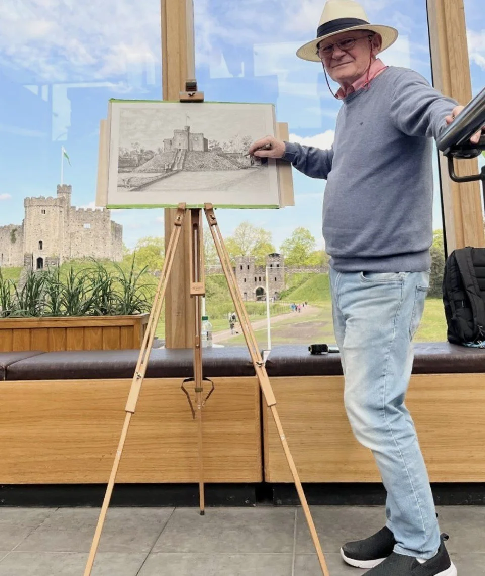 Peter hand-drawing a landscape of the old Norman Fort and the North Gate of Cardiff Castle, Cardiff, Wales.