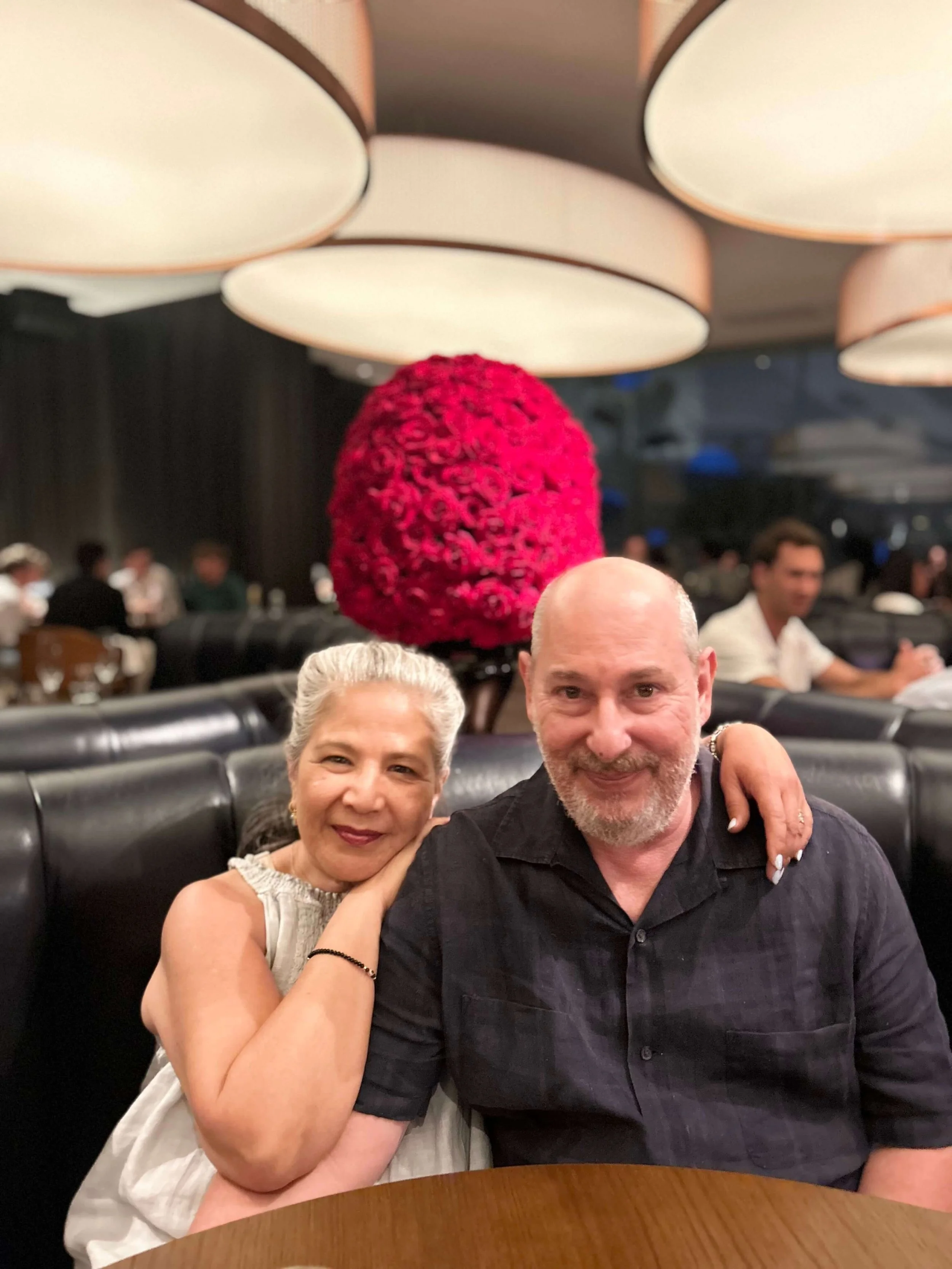 Founded Holly Strelzik leans against her husband's shoulder in a restaurant