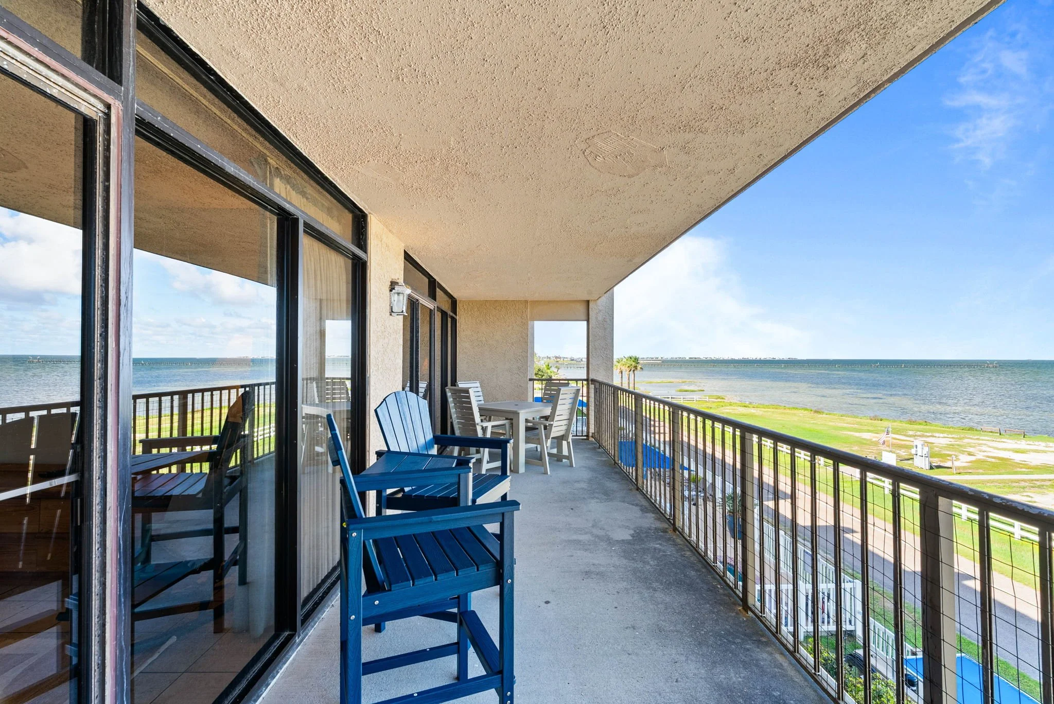 Bayfront balcony with outdoor dining and waterfront views at Rockport TX vacation rental