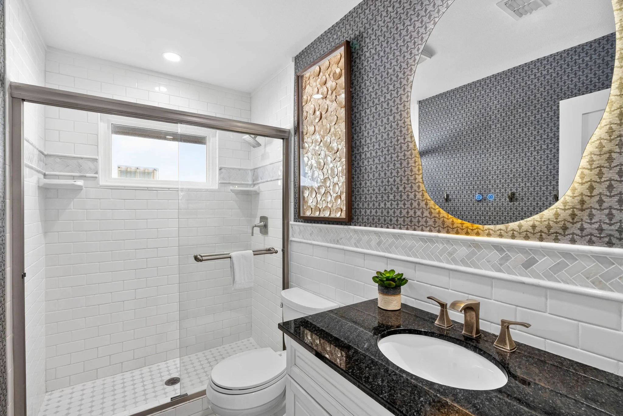 Stylish guest bathroom with walk-in glass shower at George's Landing luxury coastal home in Rockport TX 
