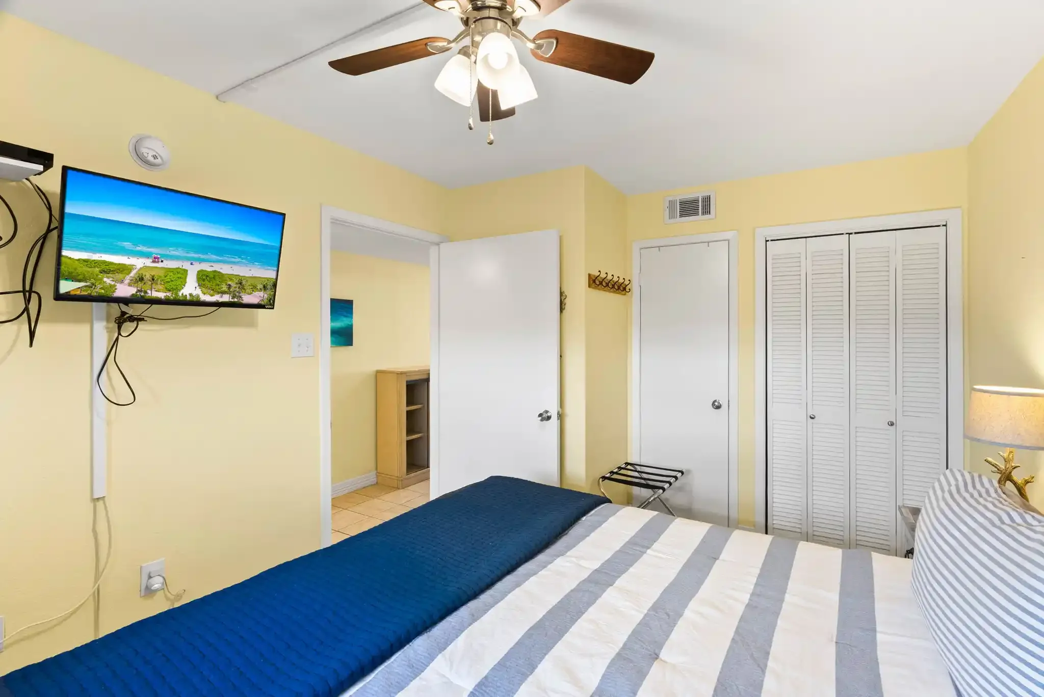 Spacious king bedroom with TV, ceiling fan and ample closet space in a comfortable Rockport, TX coastal vacation rental.