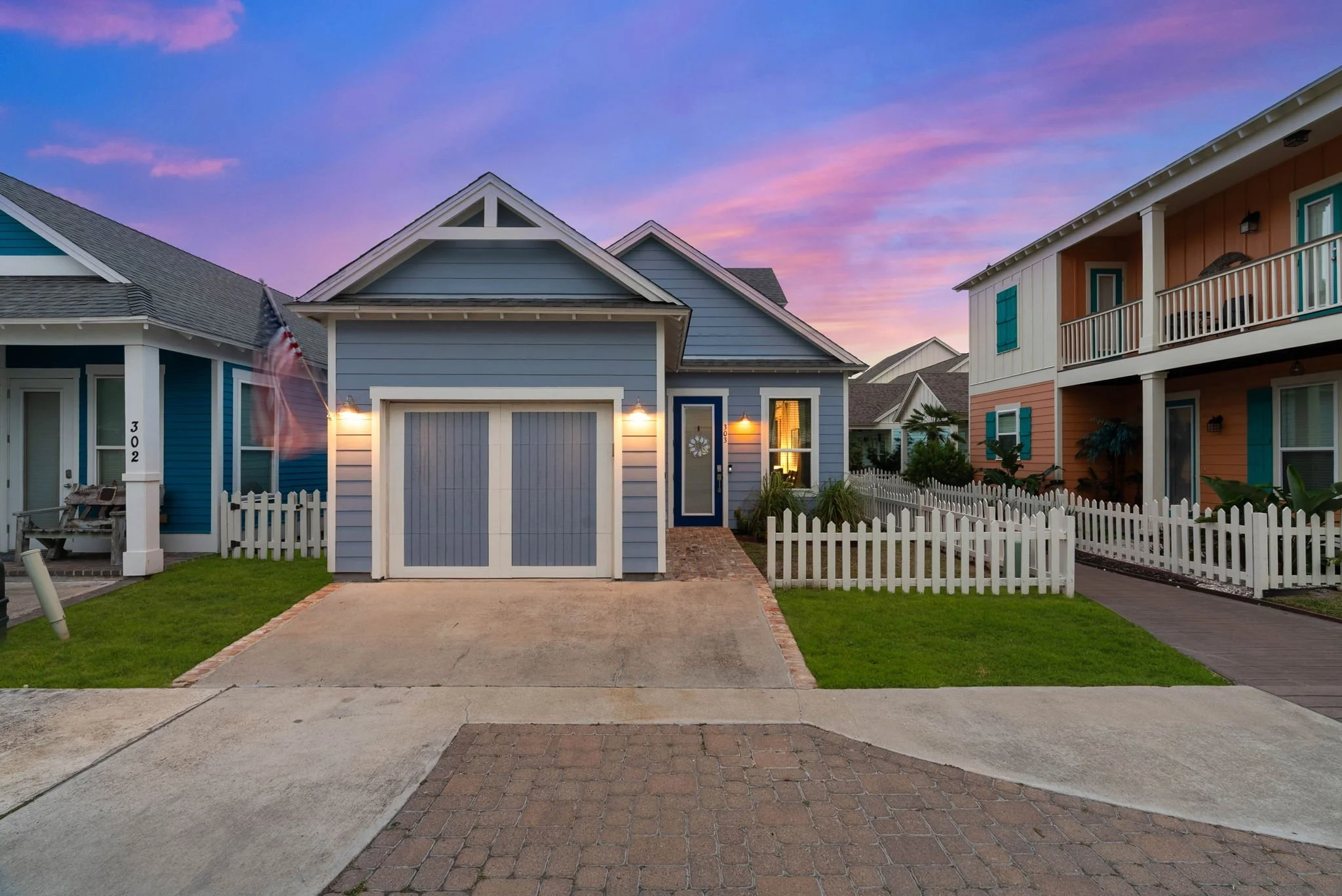 Evening view of Marina Del Rey vacation rental in Rockport TX with lit entry and American flag