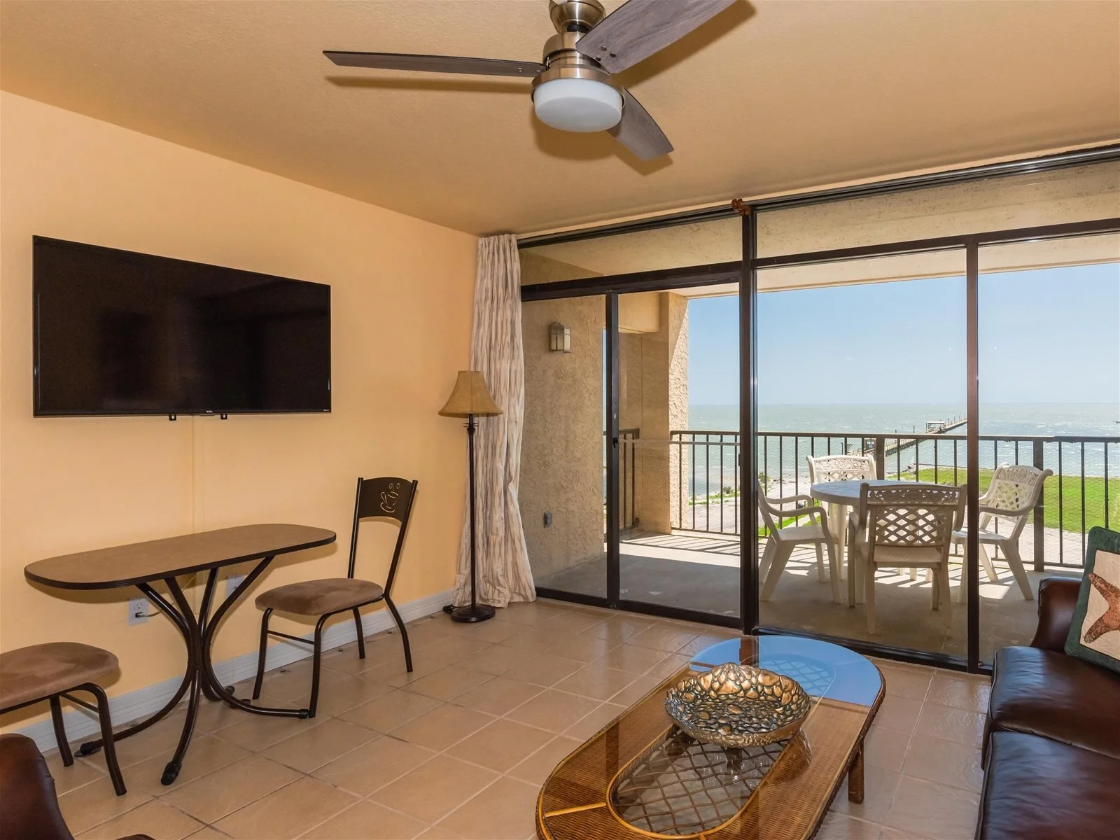 Living room with comfortable seating and balcony access – Paradise condo Rockport