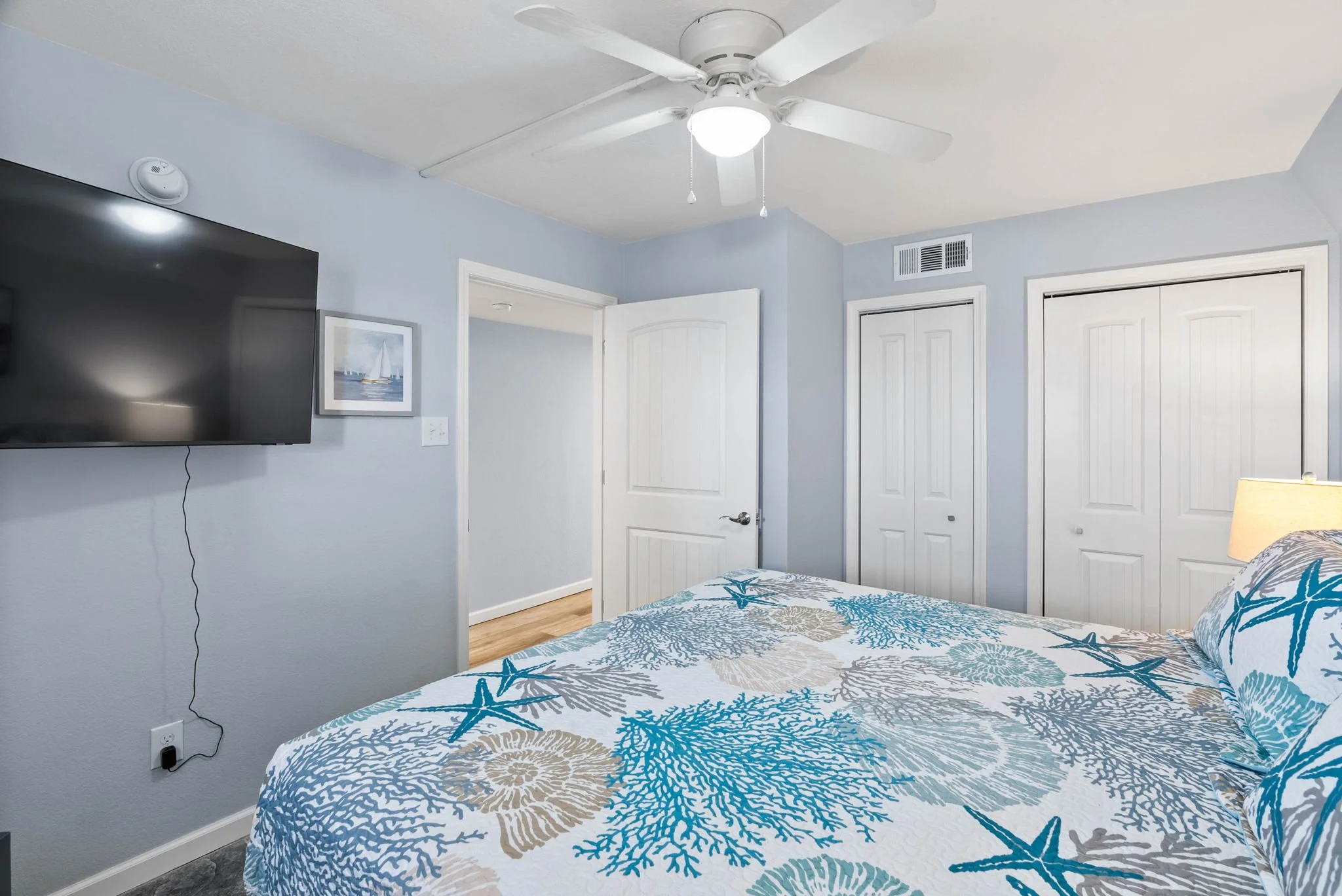 Guest bedroom with king bed and coastal artwork in Dayspring Unit 402 Laguna Reef Rockport T