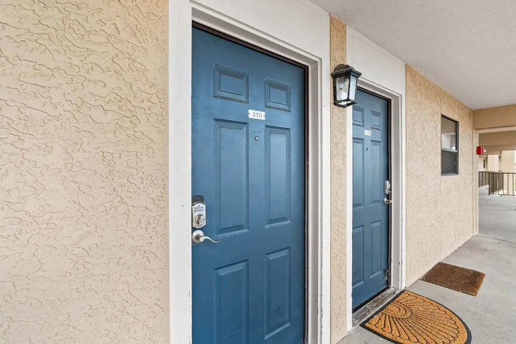 Blue front door and exterior entry to Laguna Reef Unit 310, Beauty Blues vacation rental in Rockport TX.