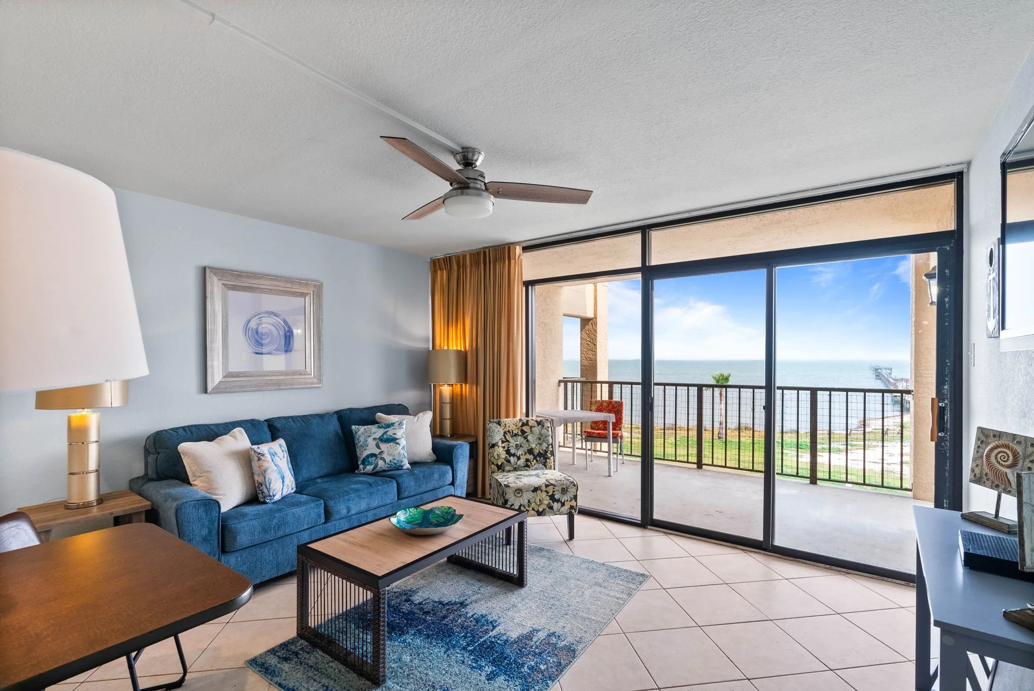 Waterfront living room with balcony and bay views at Tradewinds Unit 305 Laguna Reef Rockport TX