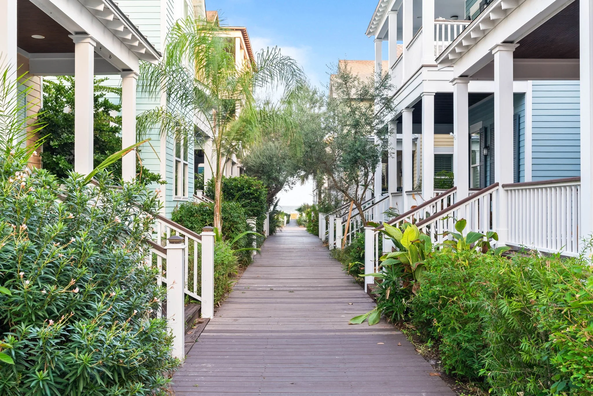 Scenic coastal boardwalk leading to the water between Marina Del Rey cottages in Rockport Texas