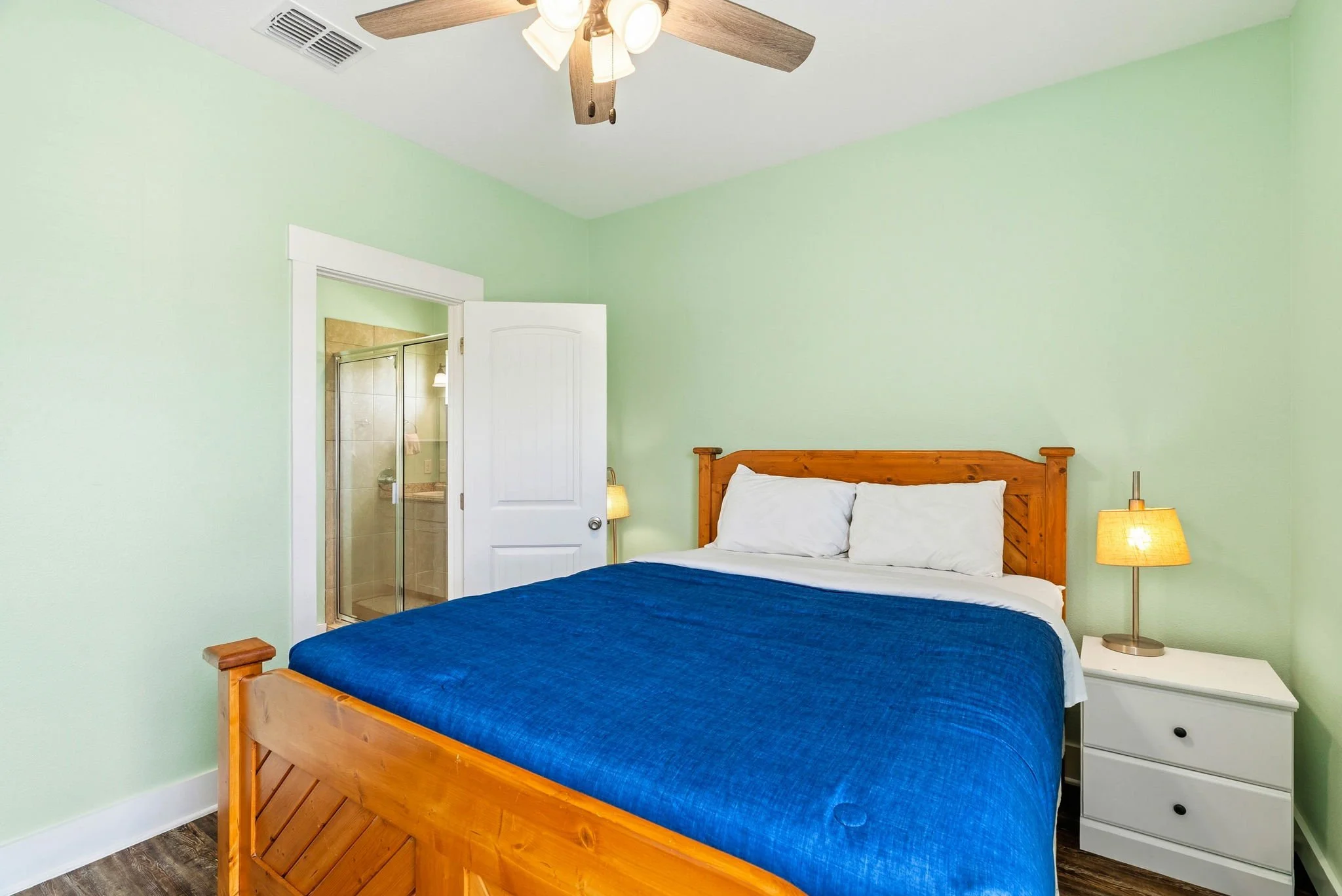 Comfortable king bedroom with private bath at Castaway Cottage Texas Coast vacation rental.