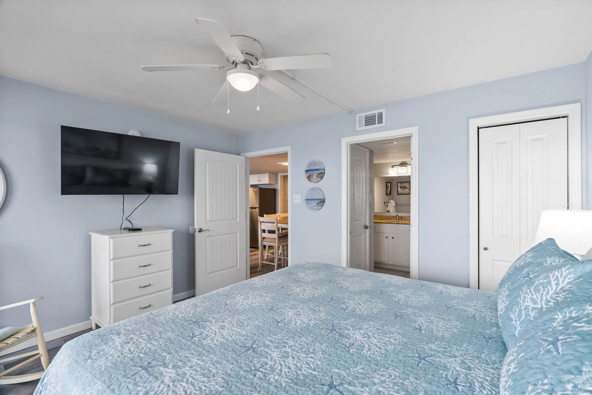 Spacious king bedroom with TV and coastal décor at Dayspring 402 Laguna Reef waterfront condo