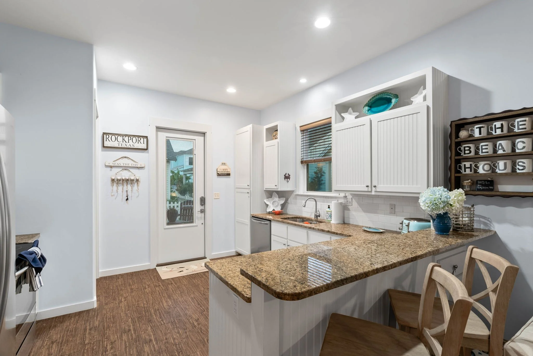 Charming coastal kitchen in Marina Del Rey Rockport vacation rental with granite countertops and beach-themed decor
