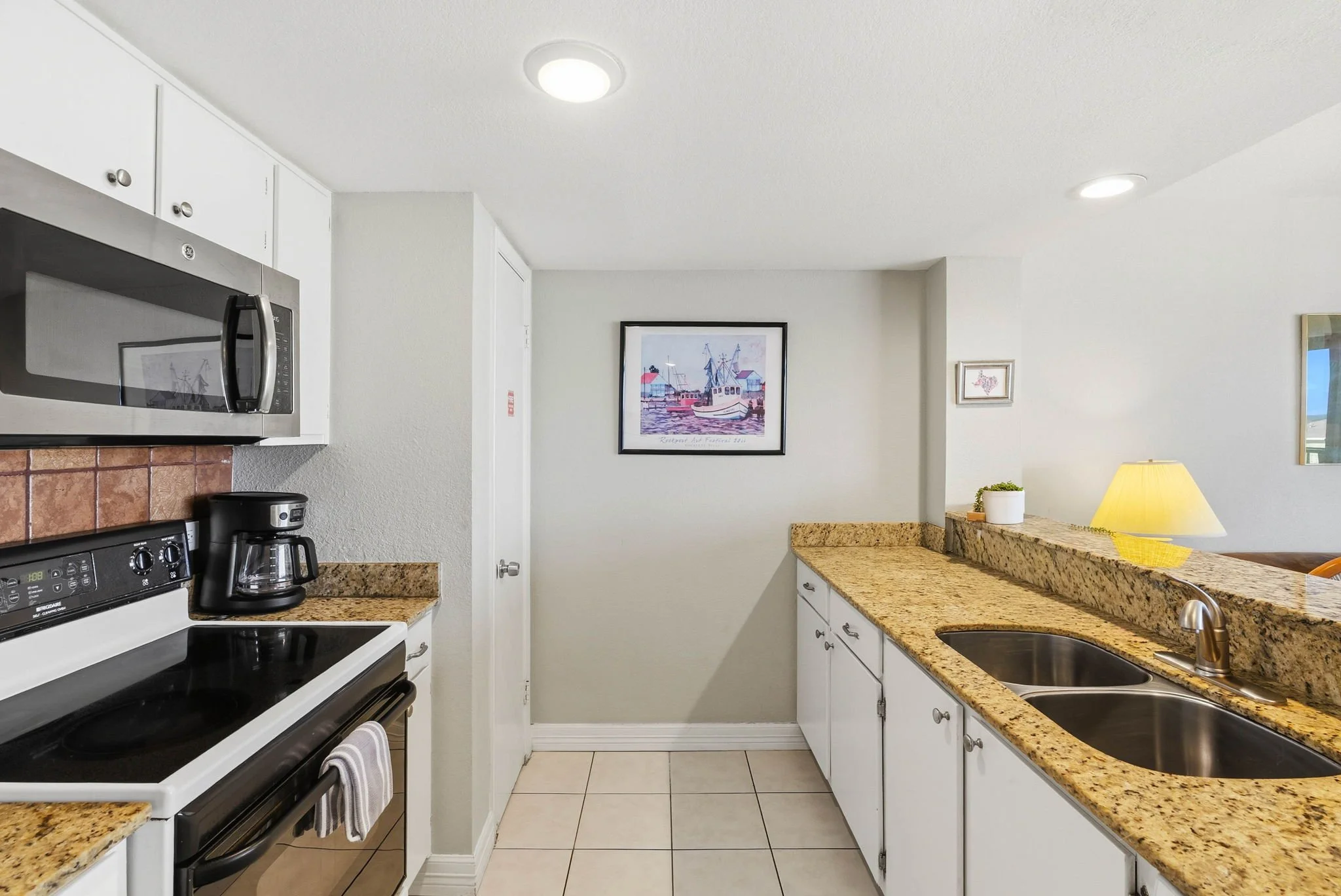 Fully equipped kitchen with granite countertops at Peaceful Pelican Laguna Reef condo