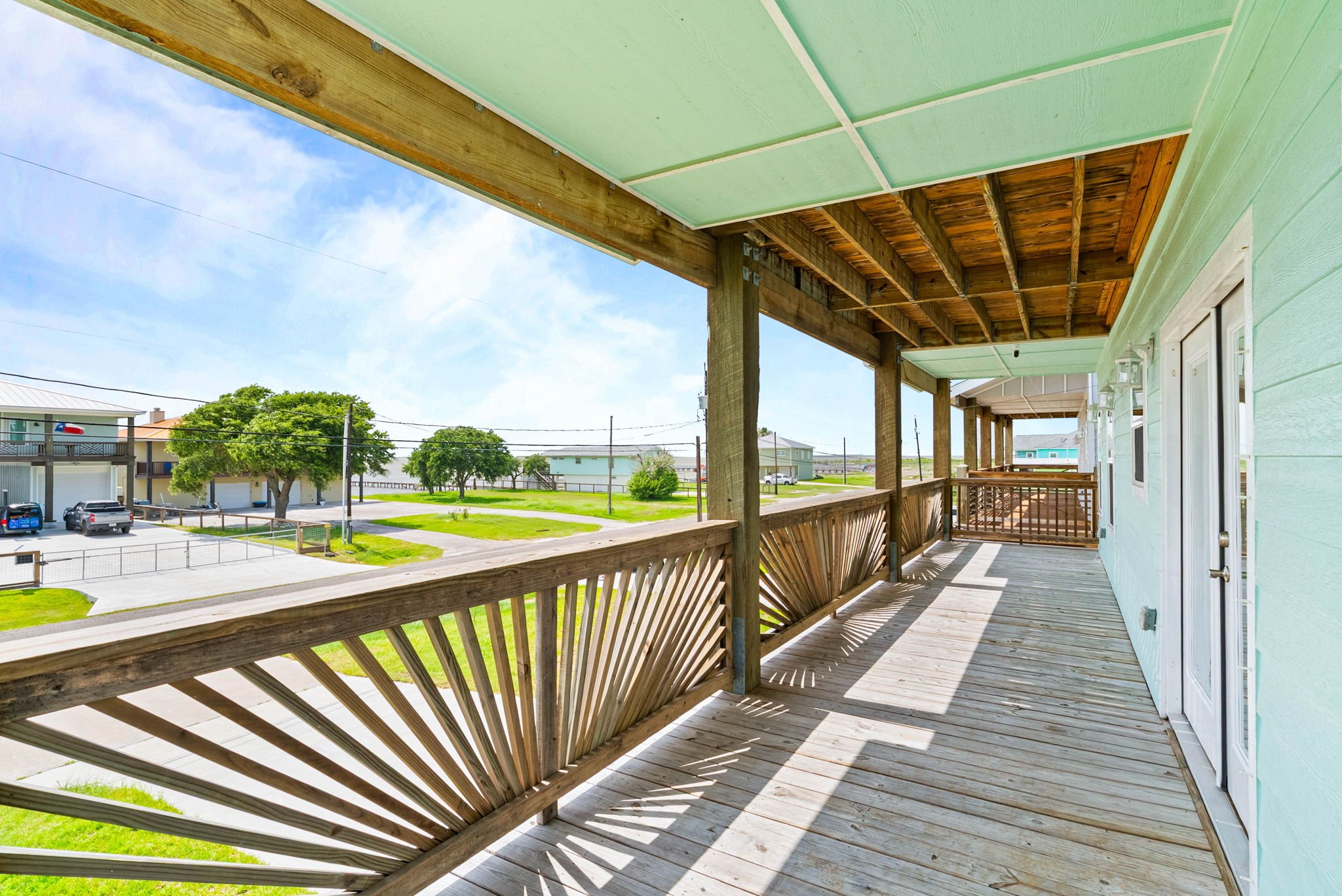 Expansive covered balcony with coastal neighborhood and distant bay views in Rockport